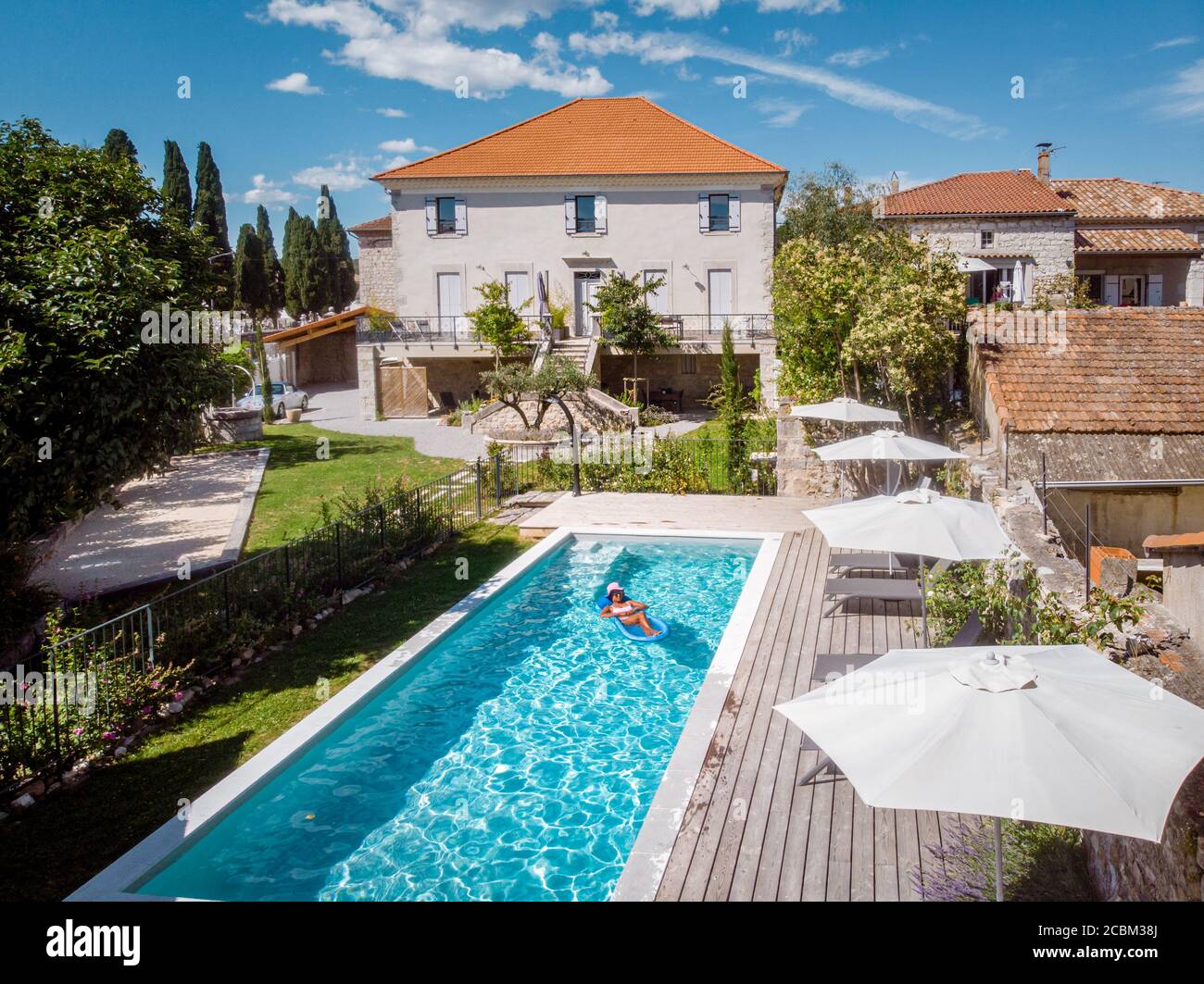 two person swim in the pool at the hotel. View from above, couple men and women in swimming pool of luxury vacation home in the Ardeche France Stock Photo