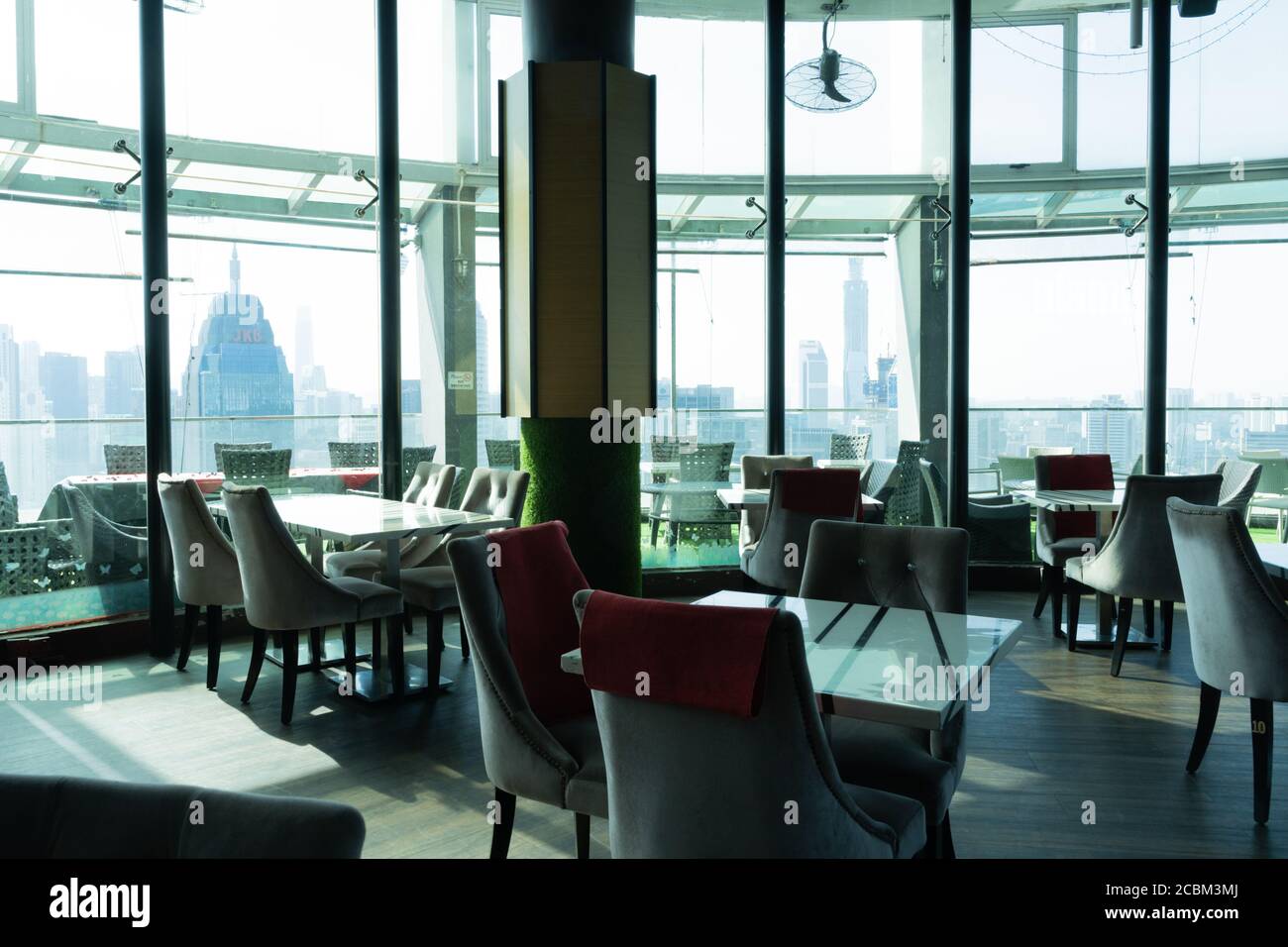 Chairs and tables inside a viewpoint overlooking the city of Kuala Lumpur in Malaysia Stock Photo