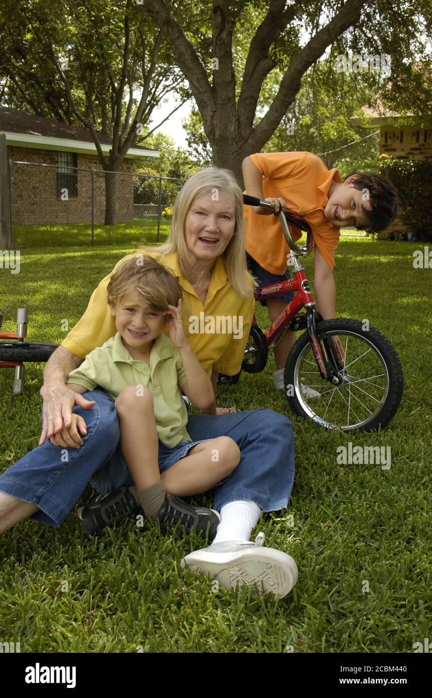 Killeen, Texas May 30, 2006: Marilyn Nolen, 61, who had twins in her mid-fifties through IVF treatment using donated eggs , relaxes with her children Travis (left, blond hair) and Ryan (right, dark hair) at their home near Fort Hood, Texas. ©Bob Daemmrich Stock Photo