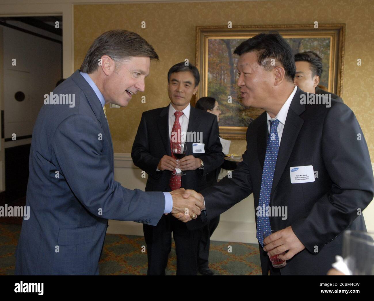 Austin, Texas May 16, 2006: Austin Mayor Will Wynn (left) greets Korean businessmen at a Samsung Semiconductor appreciation event at a local club. ©Bob Daemmrich Stock Photo