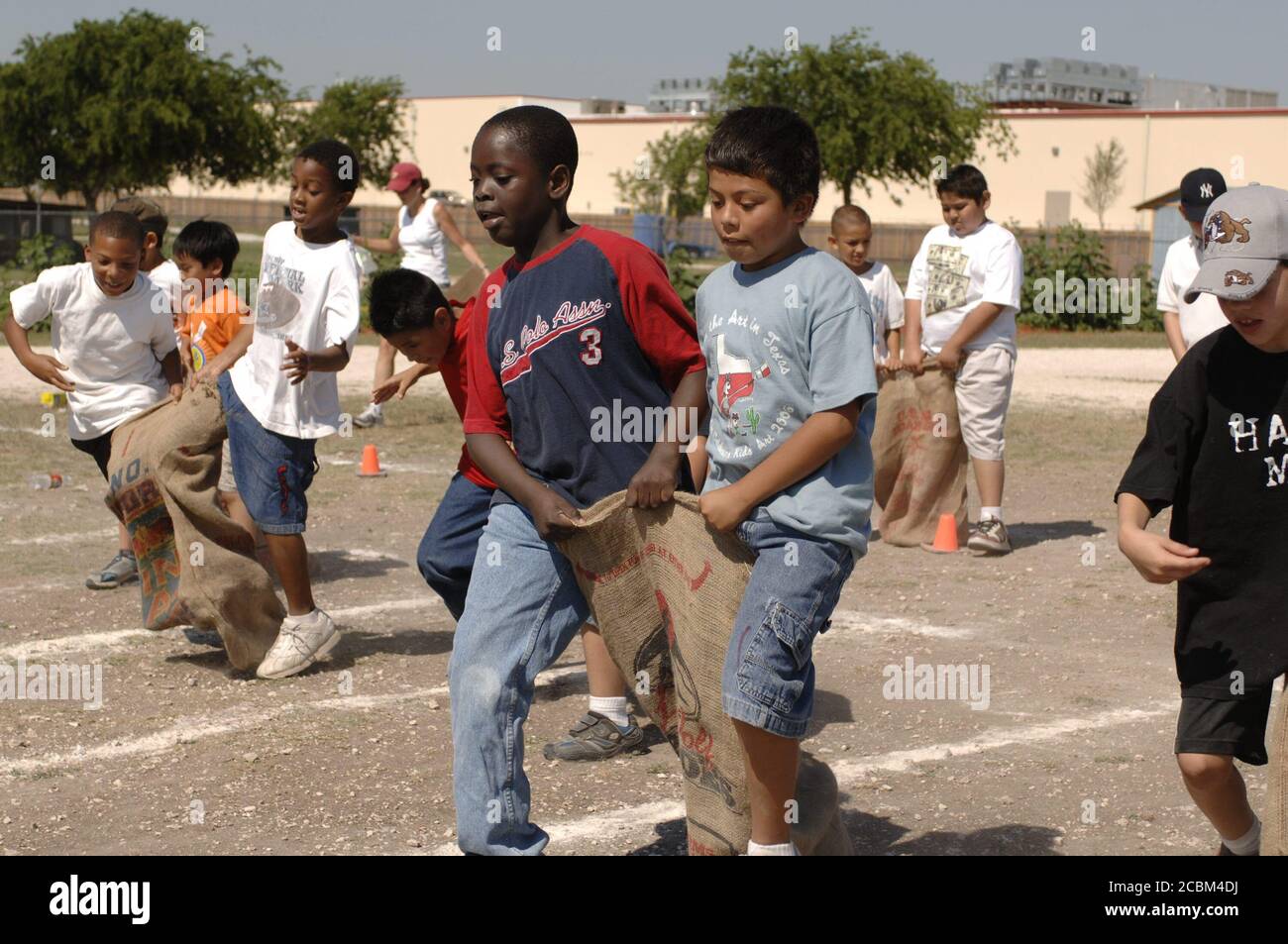 Austin Texas USA, May 2006: Fifth-grade boys compete in three-legged sack race on school playground during 'track and field day,' which traditionally marks the end of the spring semester at many area public elementary schools. ©Bob Daemmrich Stock Photo
