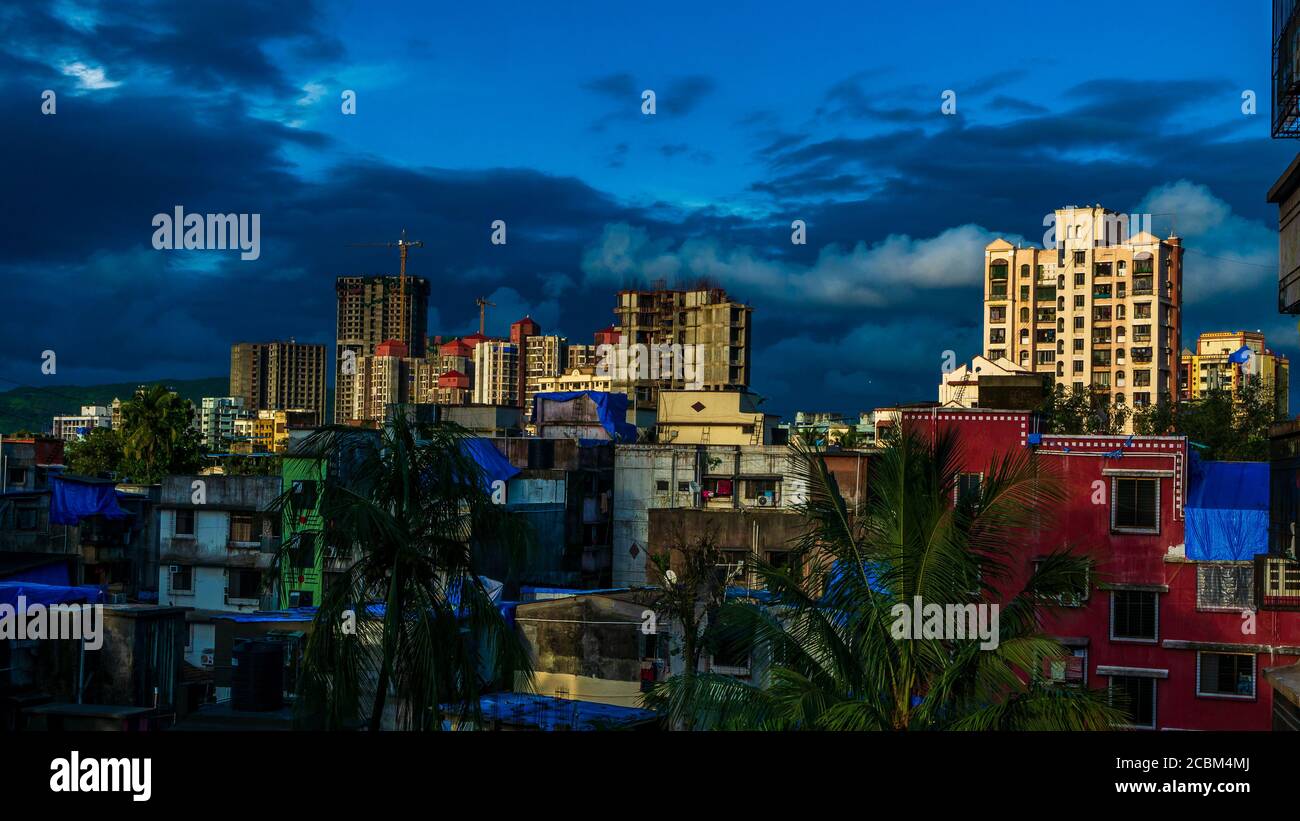 Mumbai, India - July 26, 2020 : Mumbai Cityscape, Tall residential buildings and small buildings describing lifestyle in Mumbai. Beautiful cloudy sky. Stock Photo