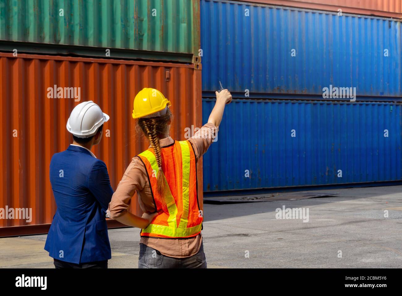 Women industrial workers and engineer are discussing the job planning in the logistic industry. Stock Photo