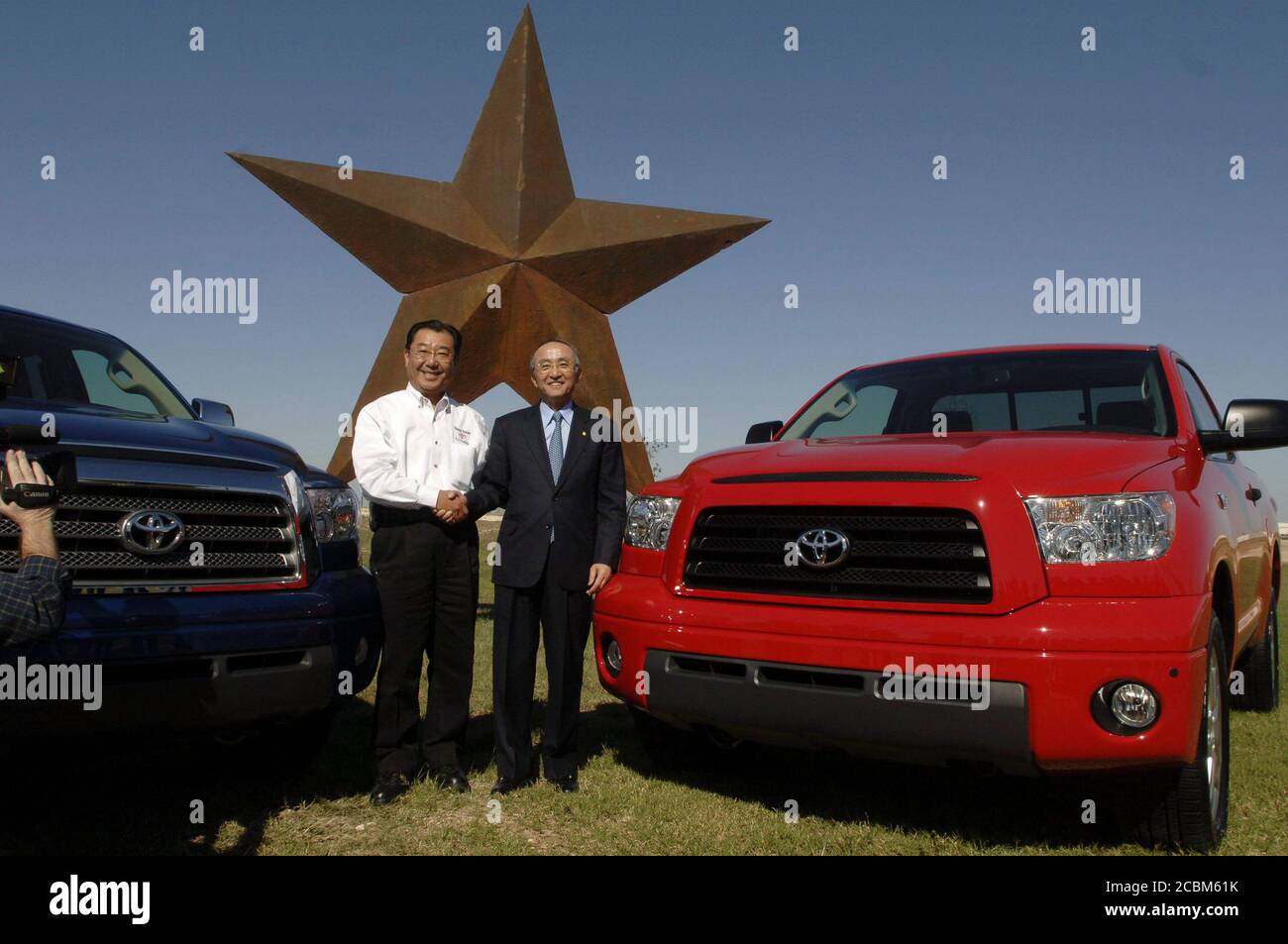 San Antonio, Texas November 17, 2006: Toyota Motor Company CEO  Katsuaki Watanabe (right) poses plant president T.J. Tajima (left) with the first two Toyota Tundra pickups off the assembly line at Toyota Motor Manufacturing's new south Texas assembly plant in Bexar County. The $1.28-billion dollar facility employs about 1,800 workers.    ©Bob Daemmrich / Stock Photo