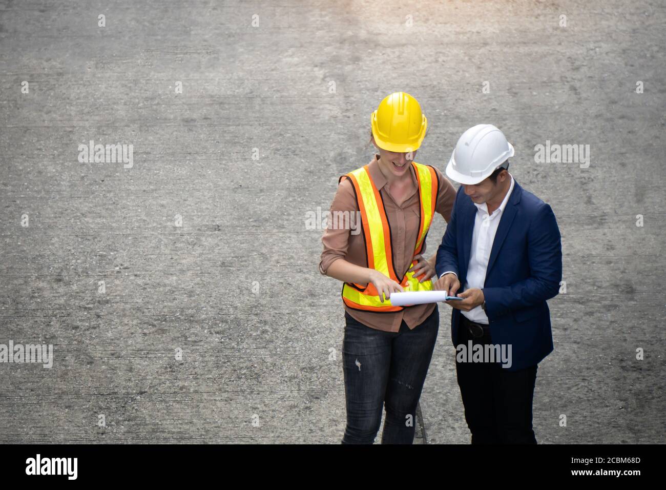 Women industrial workers and engineer are discussing the job planning in the logistic industry. Stock Photo