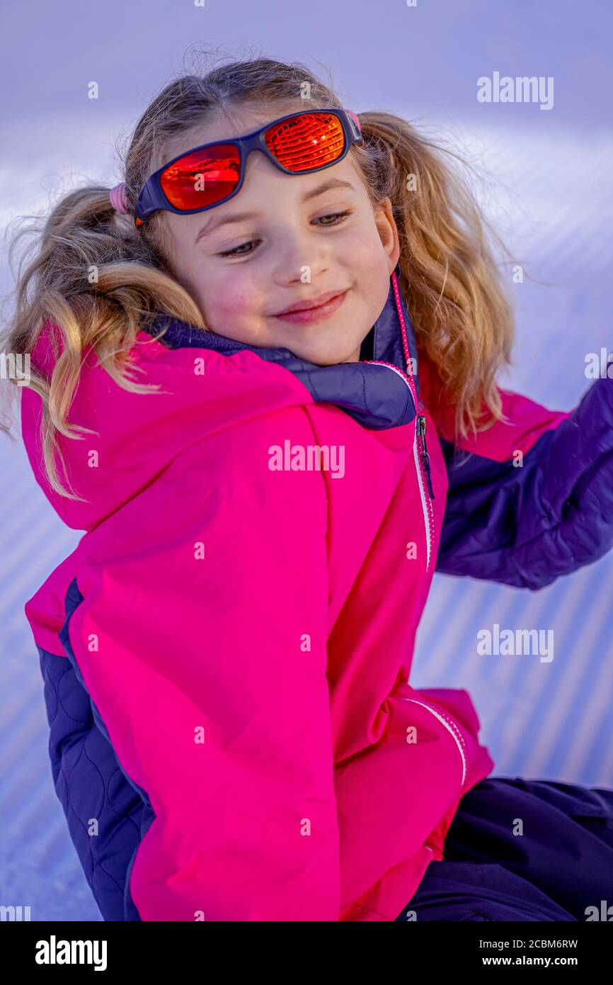 Outdoor winter portrait of little cute girl wearing ski clothes ...
