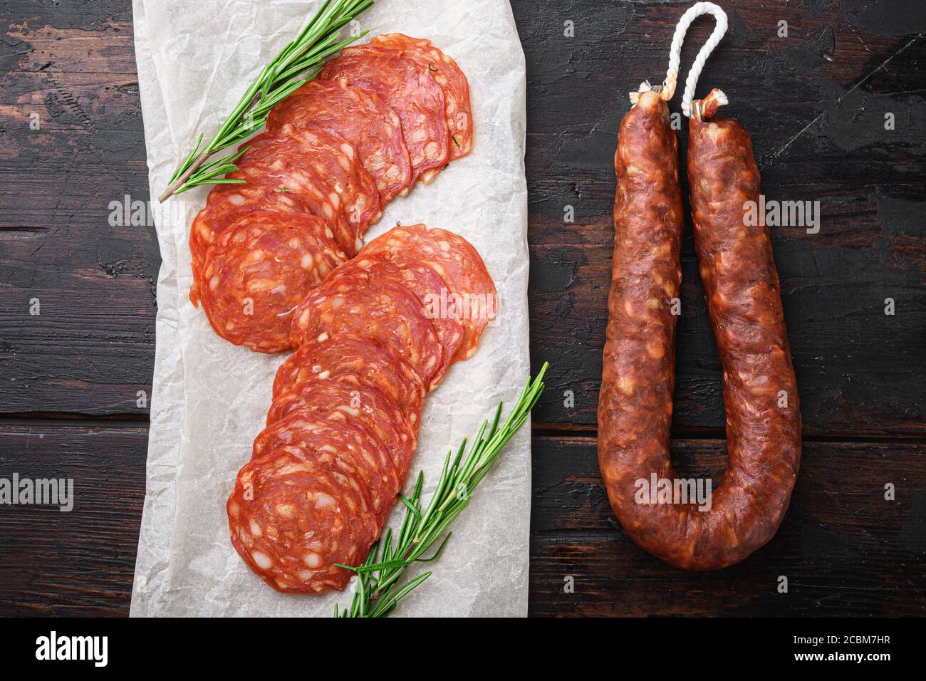 Chorizo, spanish traditional sausage cut to slices on old wooden table ...