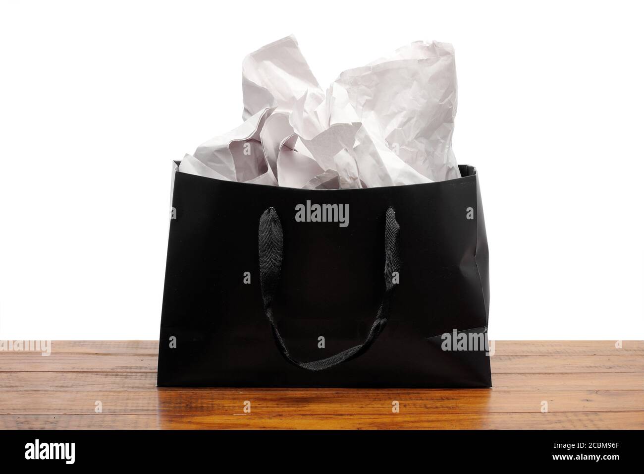 Black Paperbag on Wooden Background Stock Photo