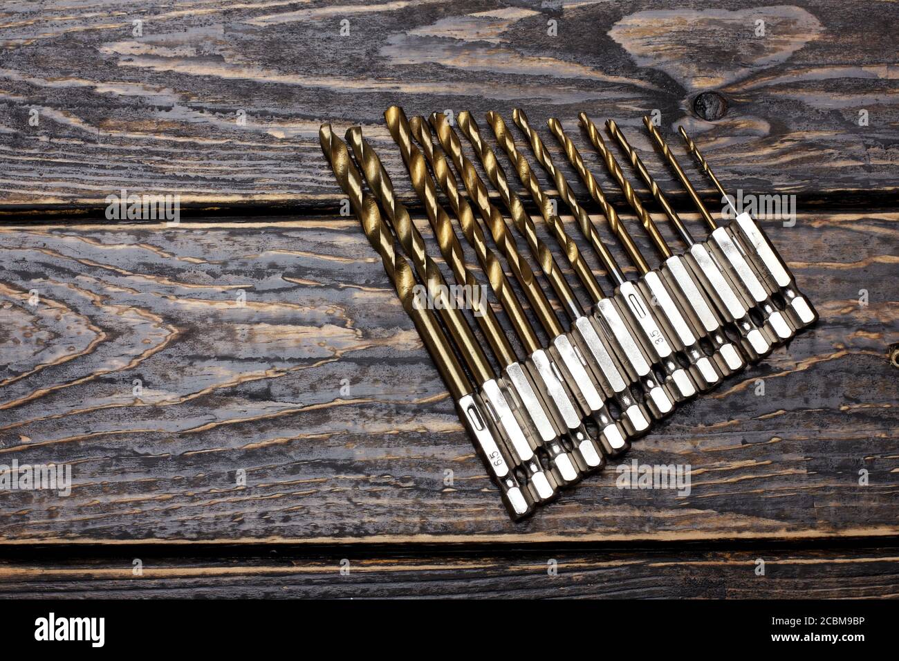 Drill Bit Set on Wooden Background Stock Photo