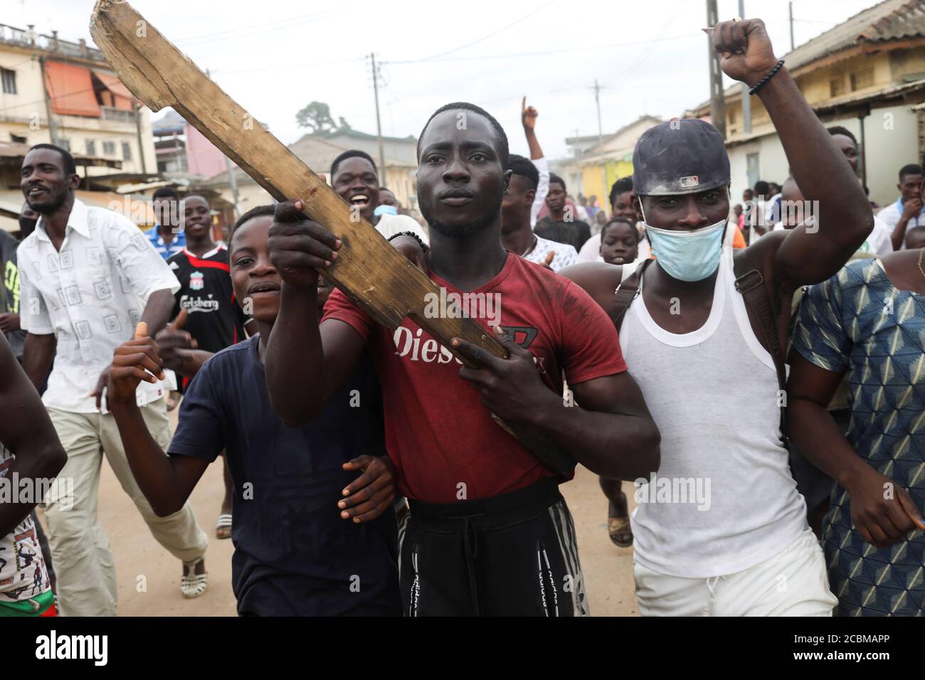 A demonstrator holds a wooden weapon a day after the clashes with police during a protest against the decision of Ivory Coast President Alassane Ouattara to run for a third term in the next presidential election, in Bonoua, Ivory Coast August 14, 2020. REUTERS/Luc Gnago Stock Photo
