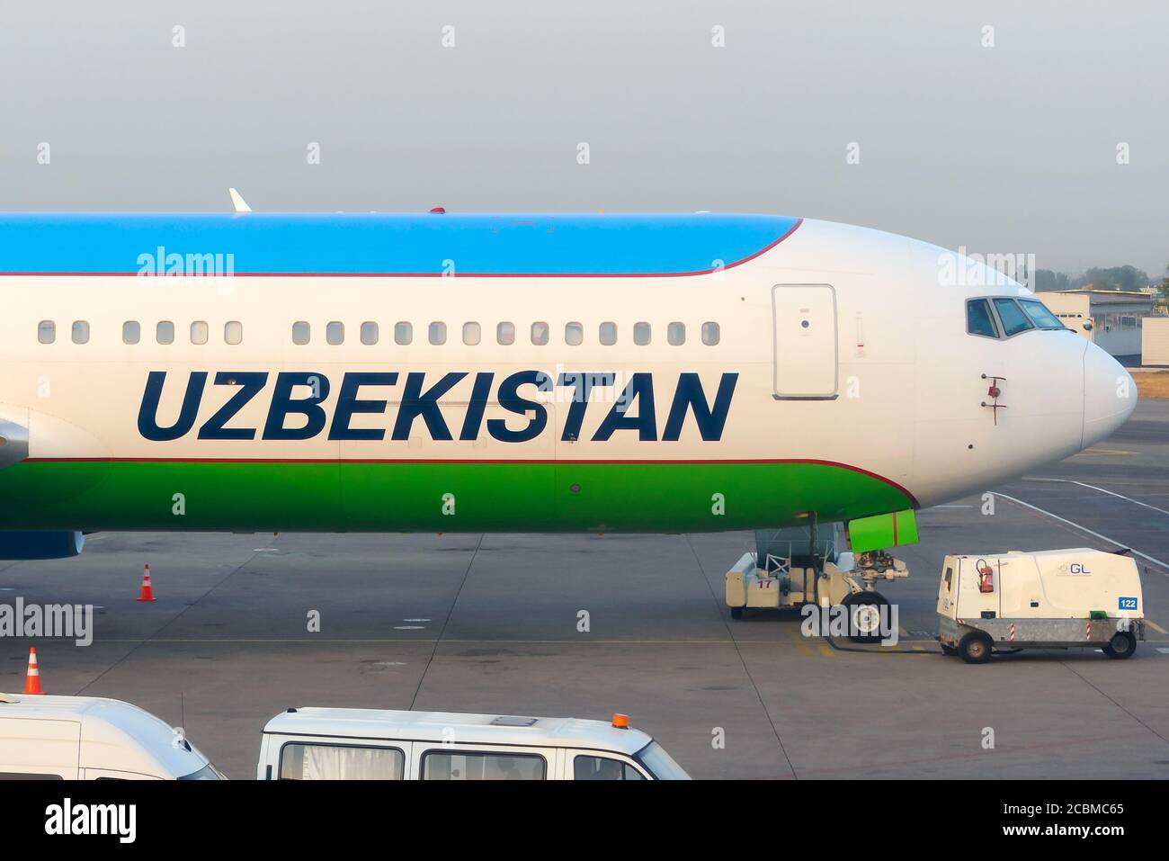 Uzbekistan Airways Boeing 767-300 parked at Islam Karimov Tashkent International Airport. UZ Airways titles on the fuselage of a 767. Stock Photo