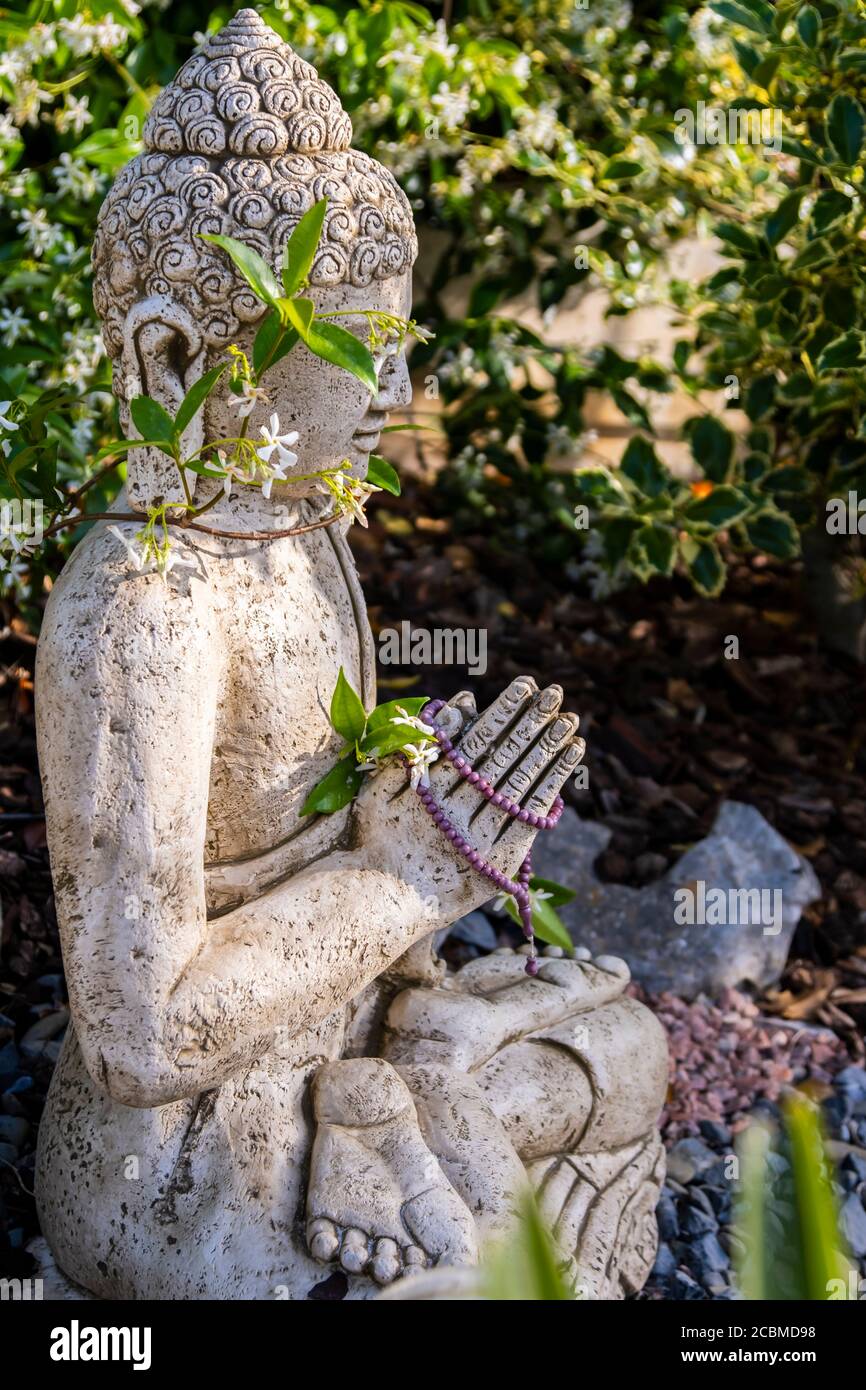 Buddha statue in a garden. Stock Photo