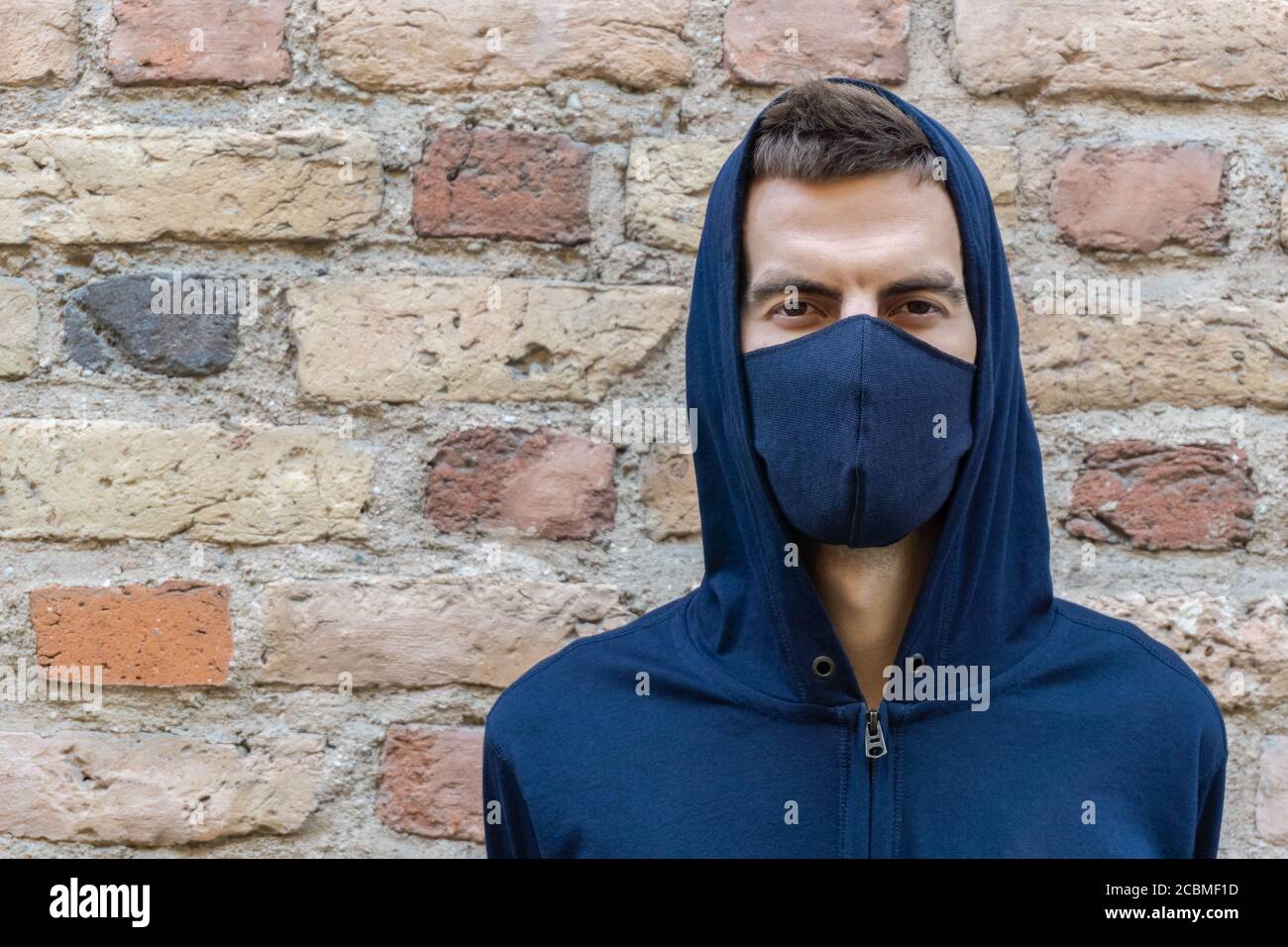 Portrait sad man wearing hood hi-res stock photography and images - Alamy