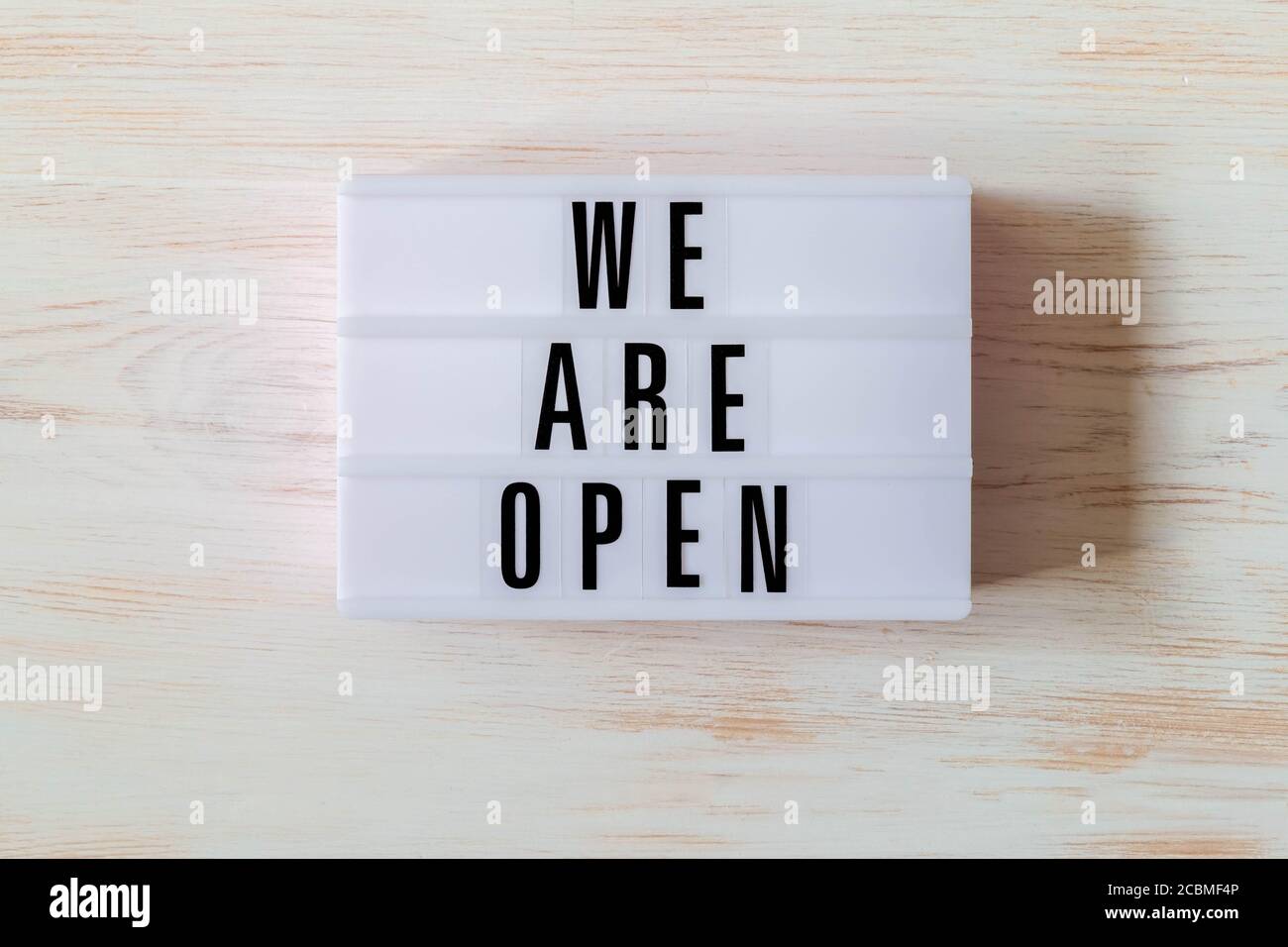 Signboard WE ARE OPEN of lightbox on wood background. Open sign hanging ...