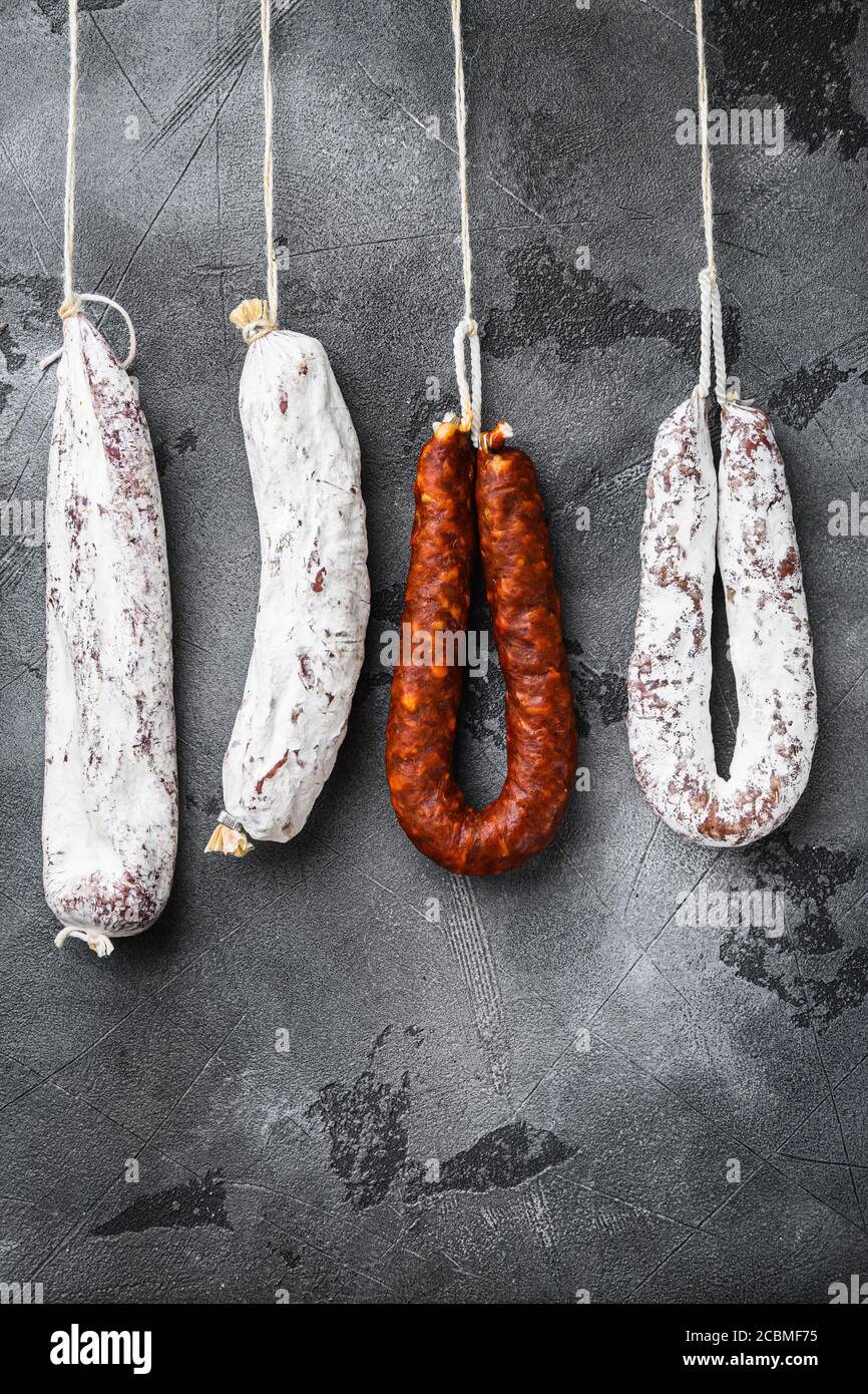 Spanish dry salami from a rack at market on grey background Stock Photo ...