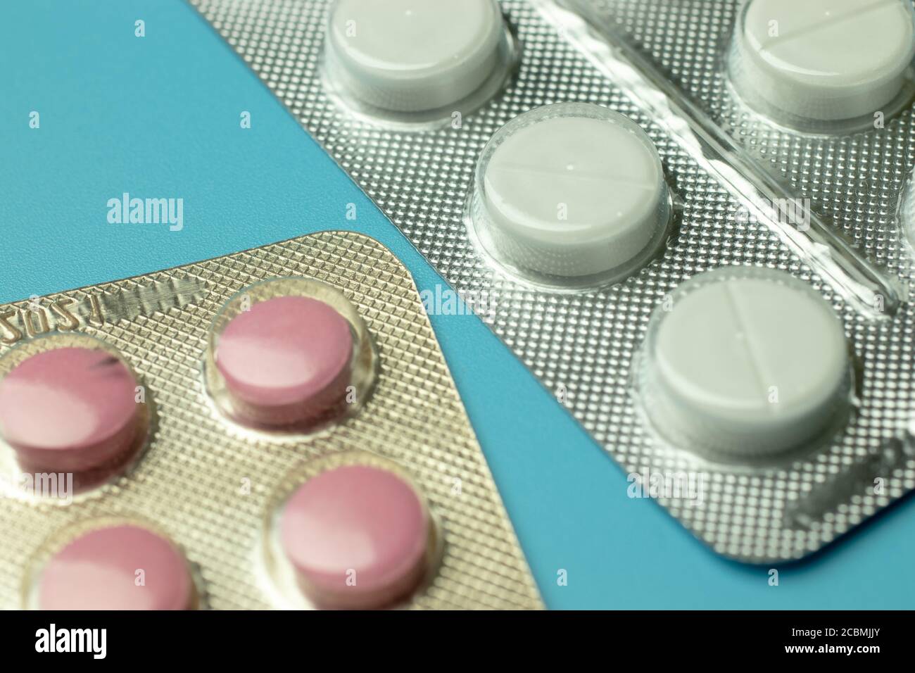Red and white pills on blue background top view Stock Photo