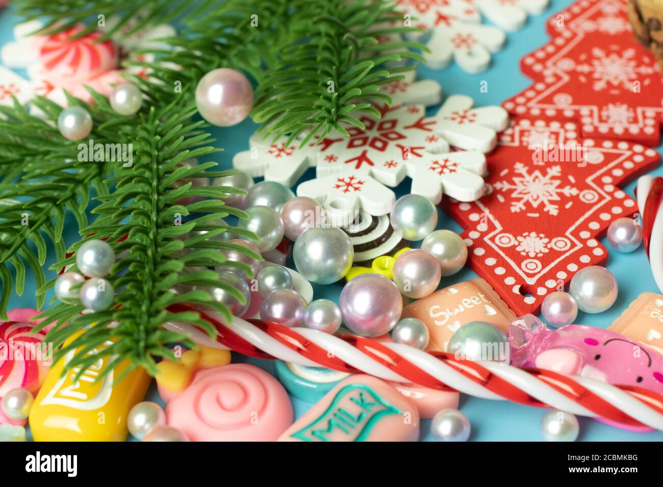 Pearls, christmas tree branch, New Year toys background. Cheerful and bright holidays design Stock Photo