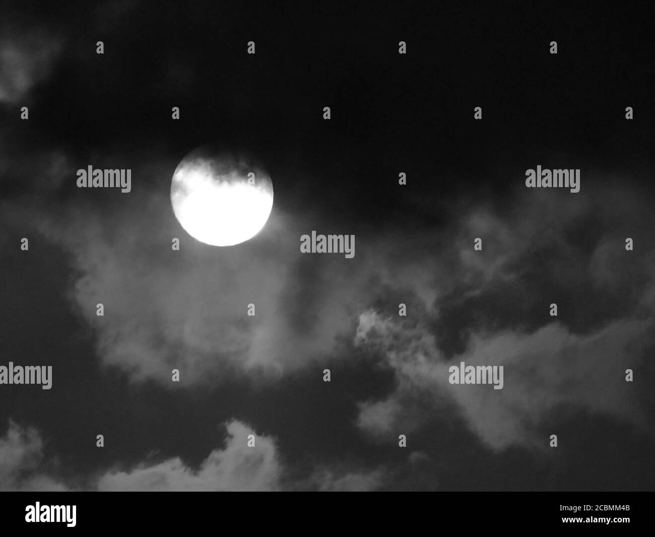 Natural background with full moon and stormy clouds Stock Photo - Alamy