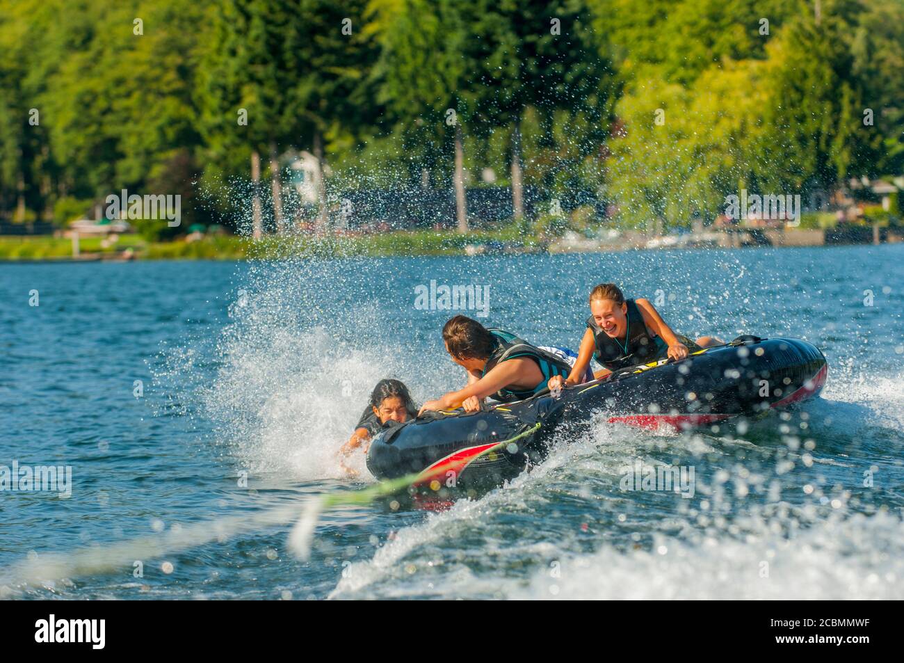 Teenagers inner tubing on Lake Samish near Bellingham in Whatcam County