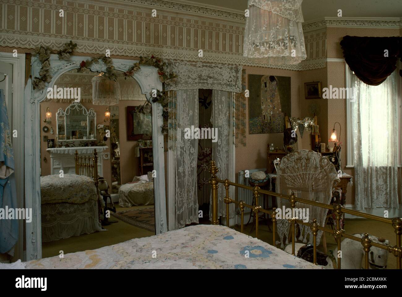 Edwardian bedroom with large mirror and lace Stock Photo