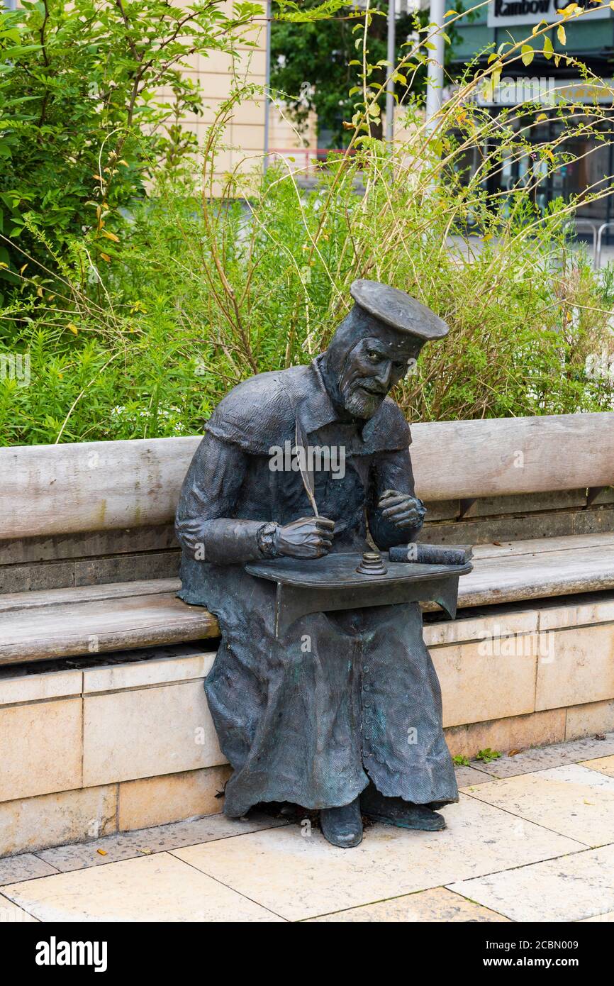 Bronze statue of sitting William Tyndale, Protestant reformer, by Thomas Holocener. Millenium Square, Bristol England. July 2020 Stock Photo