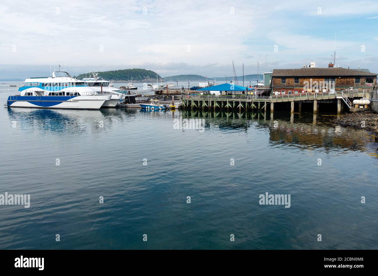 View of a harbor with a cabin cruiser in Bar Harbor Maine. Stock Photo