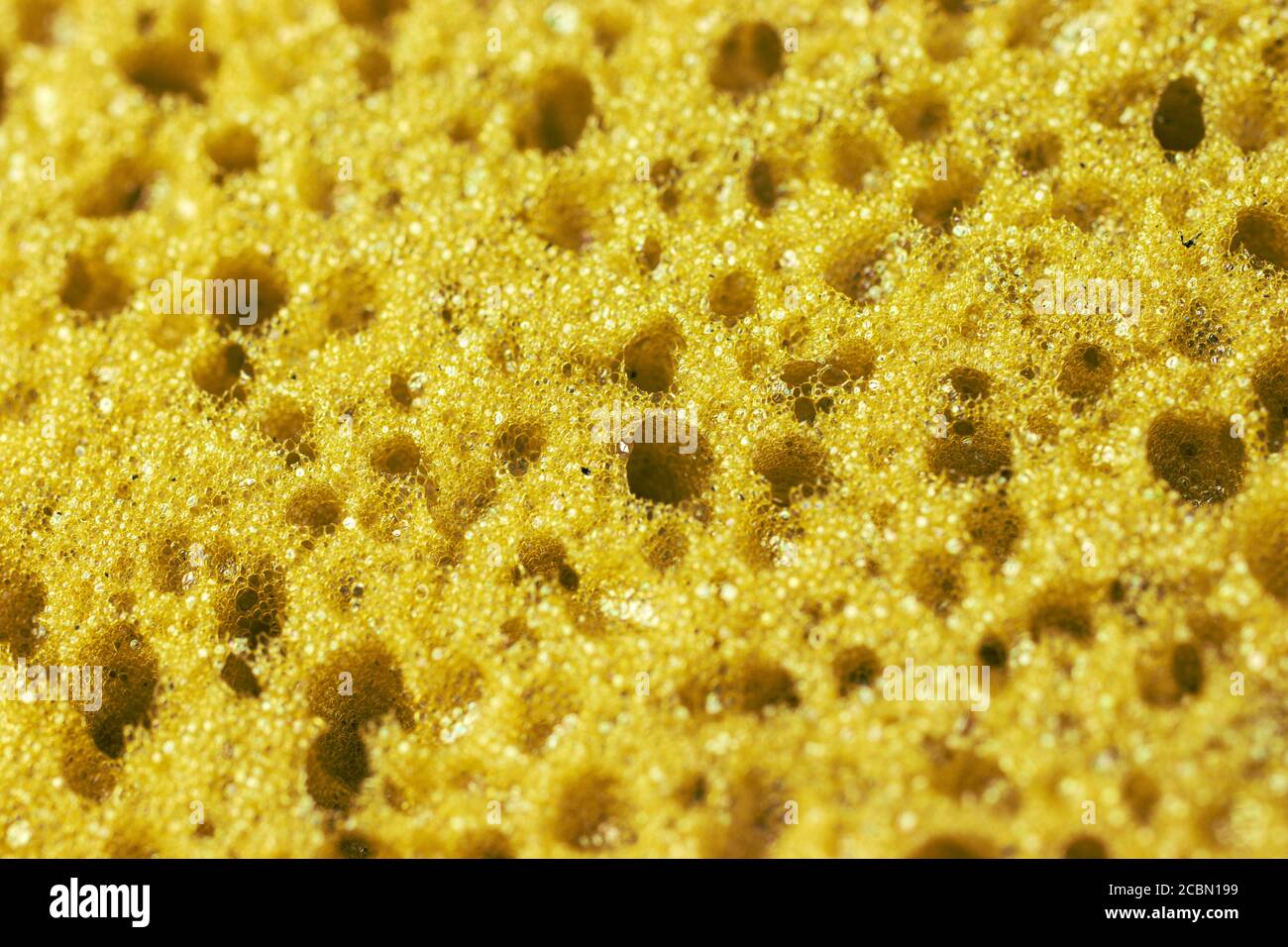 Yellow texture background with holes. Macro photo Stock Photo