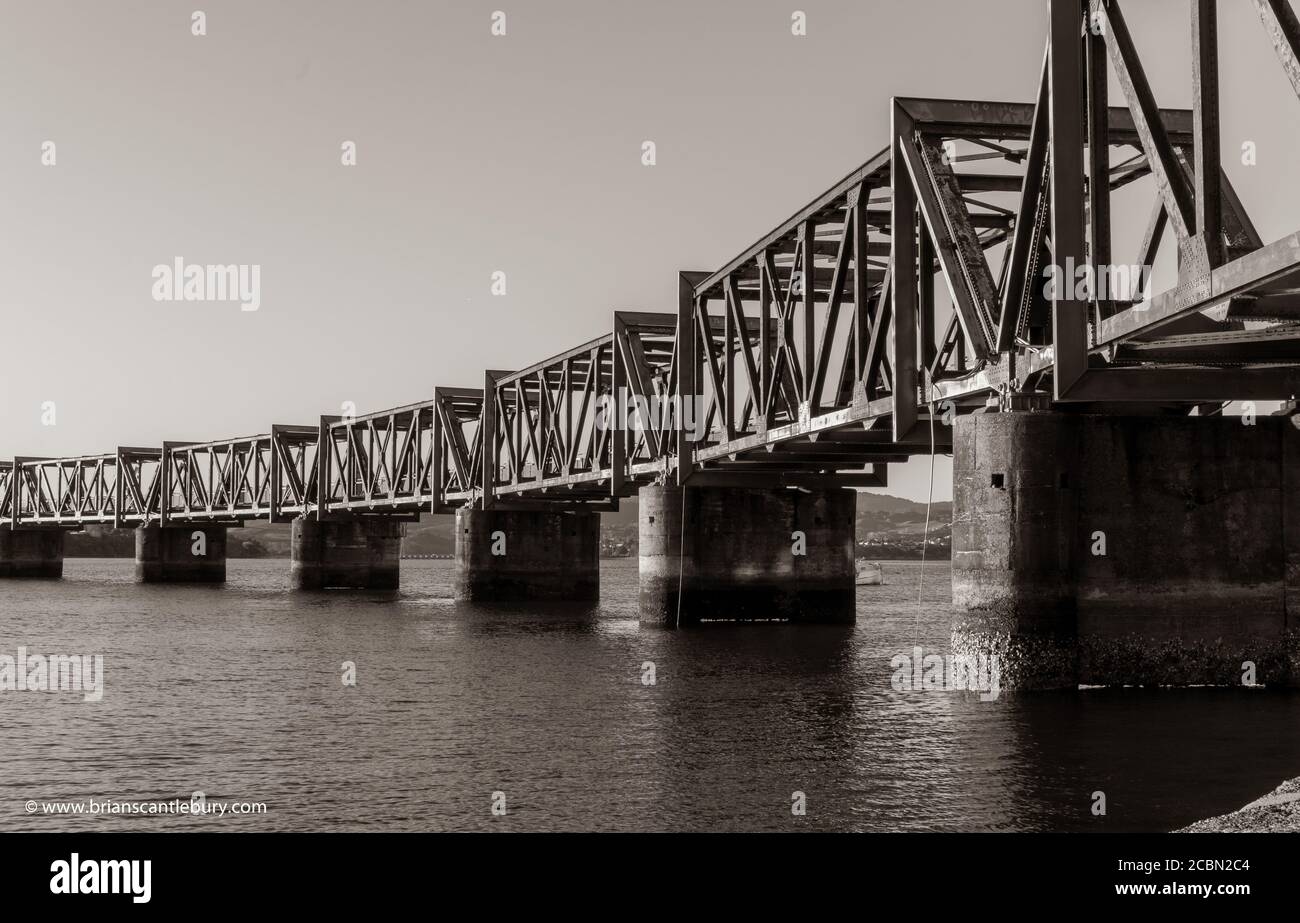 Old-fashioned steel truss railway bridge across Tauranga harbour,  New Zealand. Stock Photo