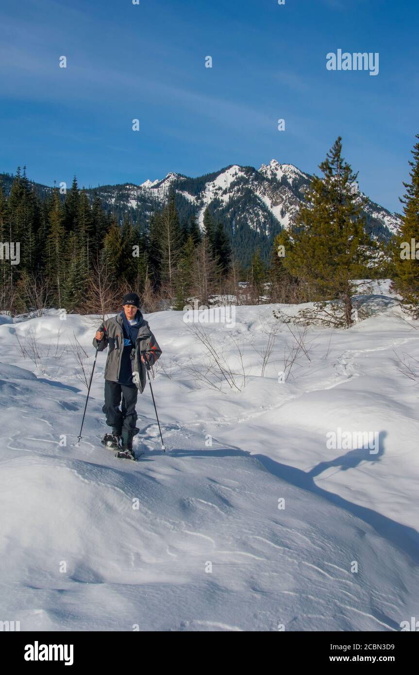 A teenage boy (model released) is snowshoeing at Gold Creek in the