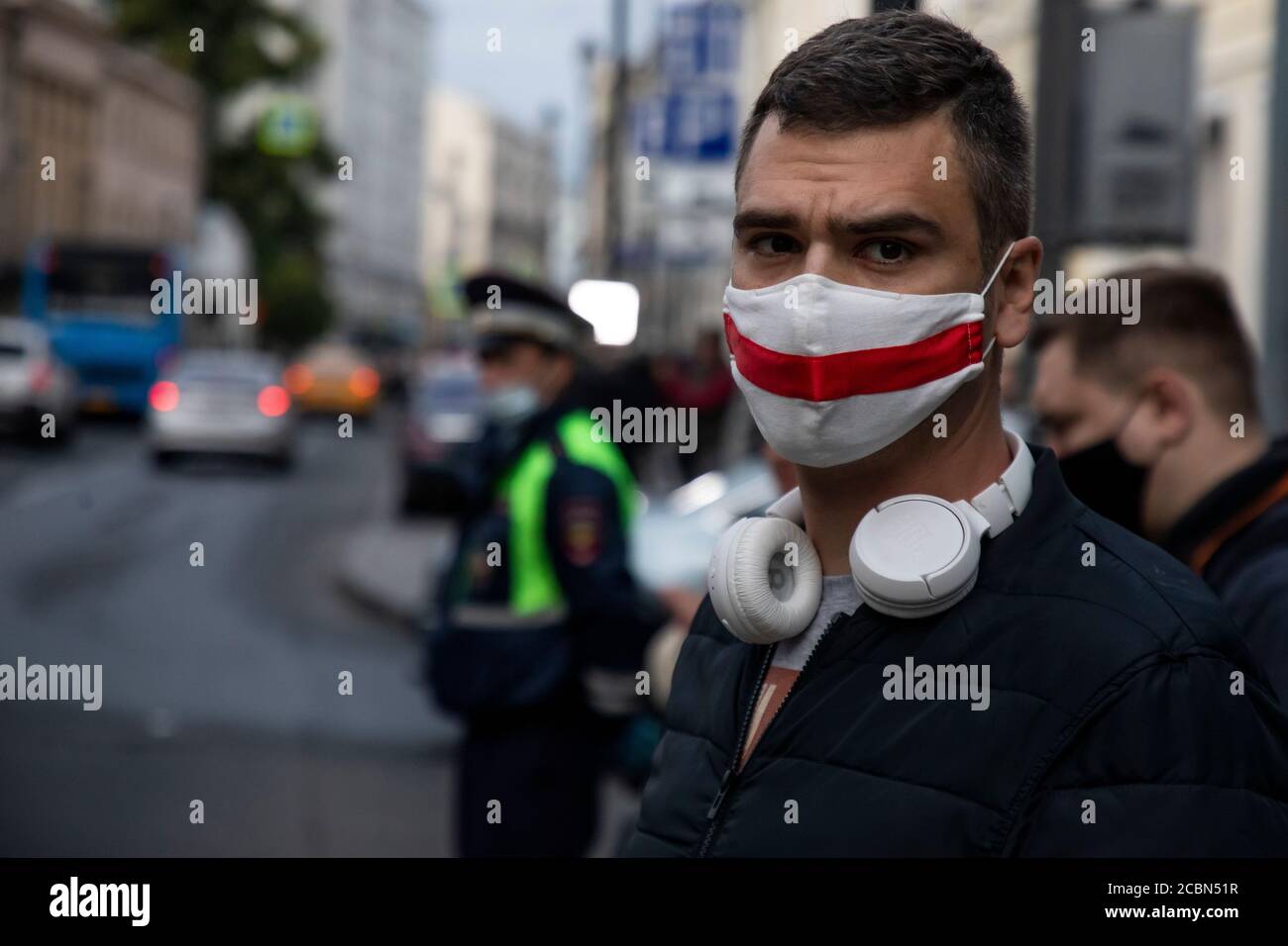 Moscow, Russia. 14th of August, 2020 A man wears a face mask in color of Belorussian flag during a picket outside the Belarusian Embassy in support of Belarusians protesting against the official results of the 2020 Belarusian presidential election Stock Photo