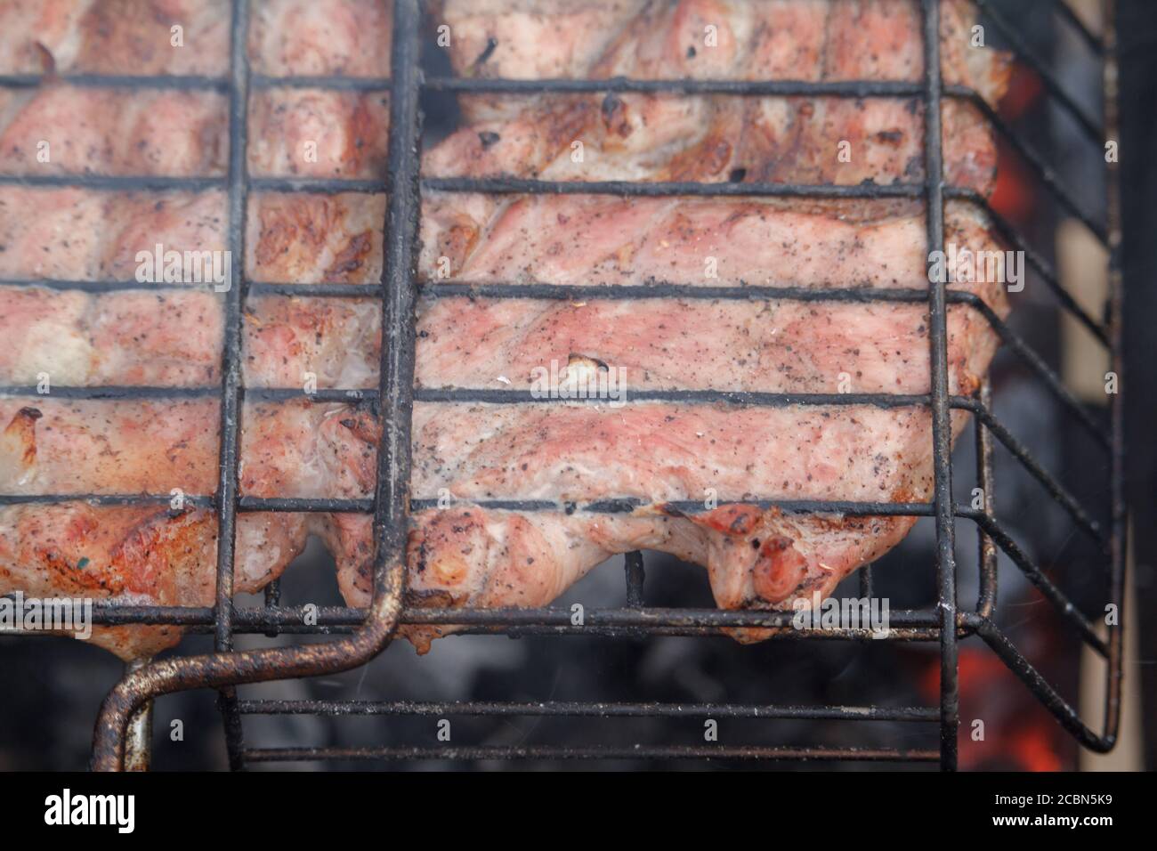 Close-up beef or pork meat barbecue prepared grilled on bbq fire flame grill, view from above Stock Photo