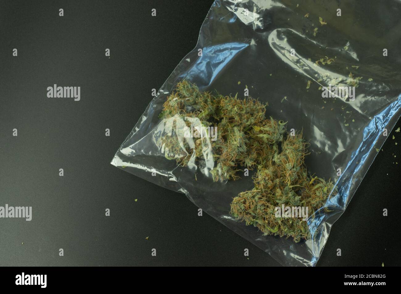 Package zip lock with cannabis buds. Street drug business. Illegal marijuana selling. Criminal weed concept Stock Photo
