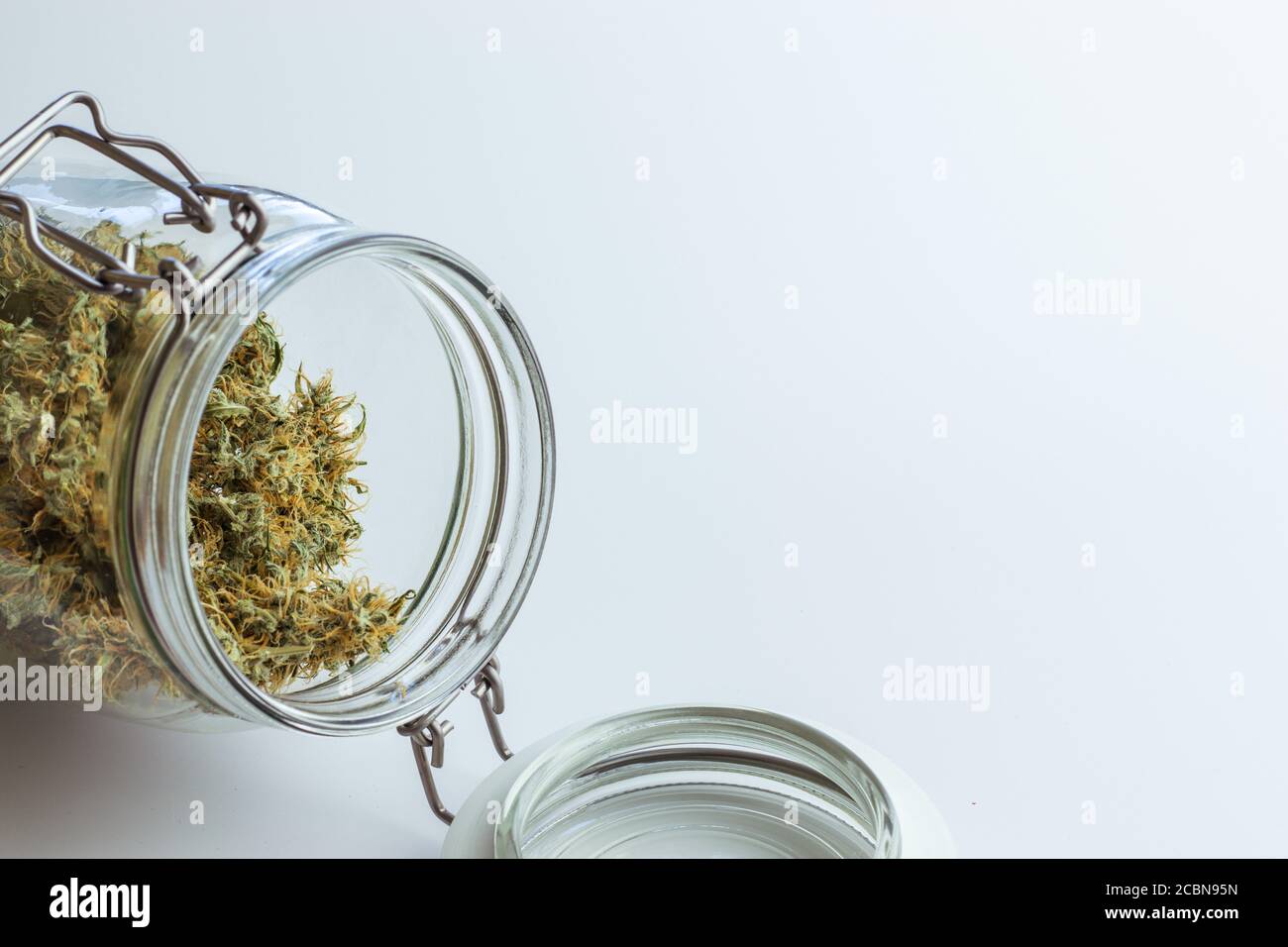 Open jar with cannabis buds. Dry marijuana for medical use. Weed