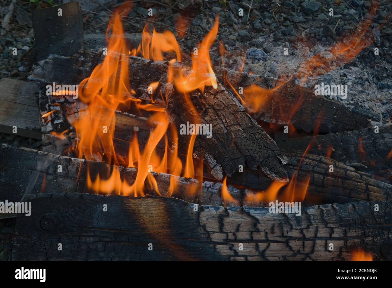 Burning log of wood closeup as abstract background. The hot embers of
