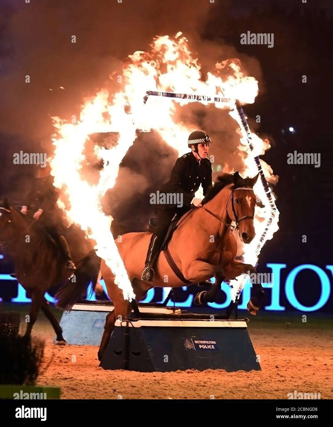 The Metropolitan Police musical ride through hoops of fire Equestrian Stock Photo