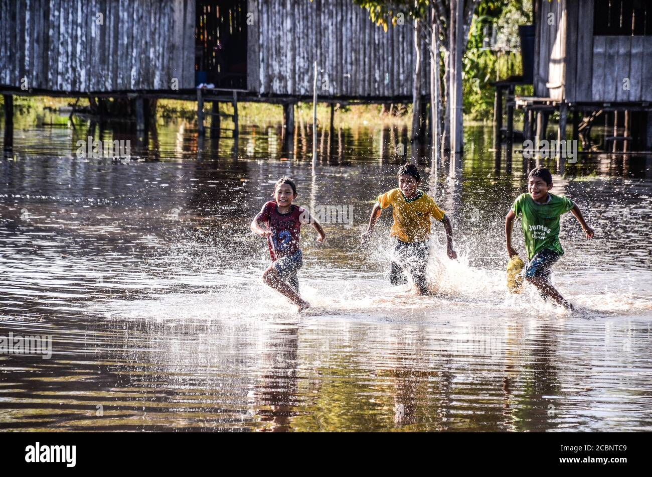 Boys running on water Stock Photo
