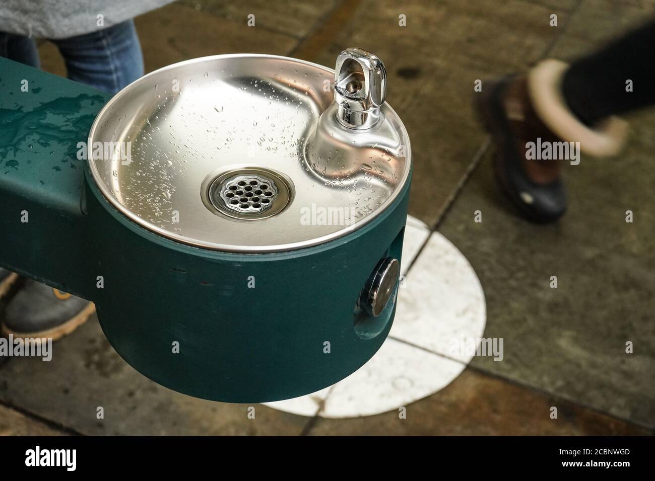 Clean stainless steel drinking water fountain on the street, blurred