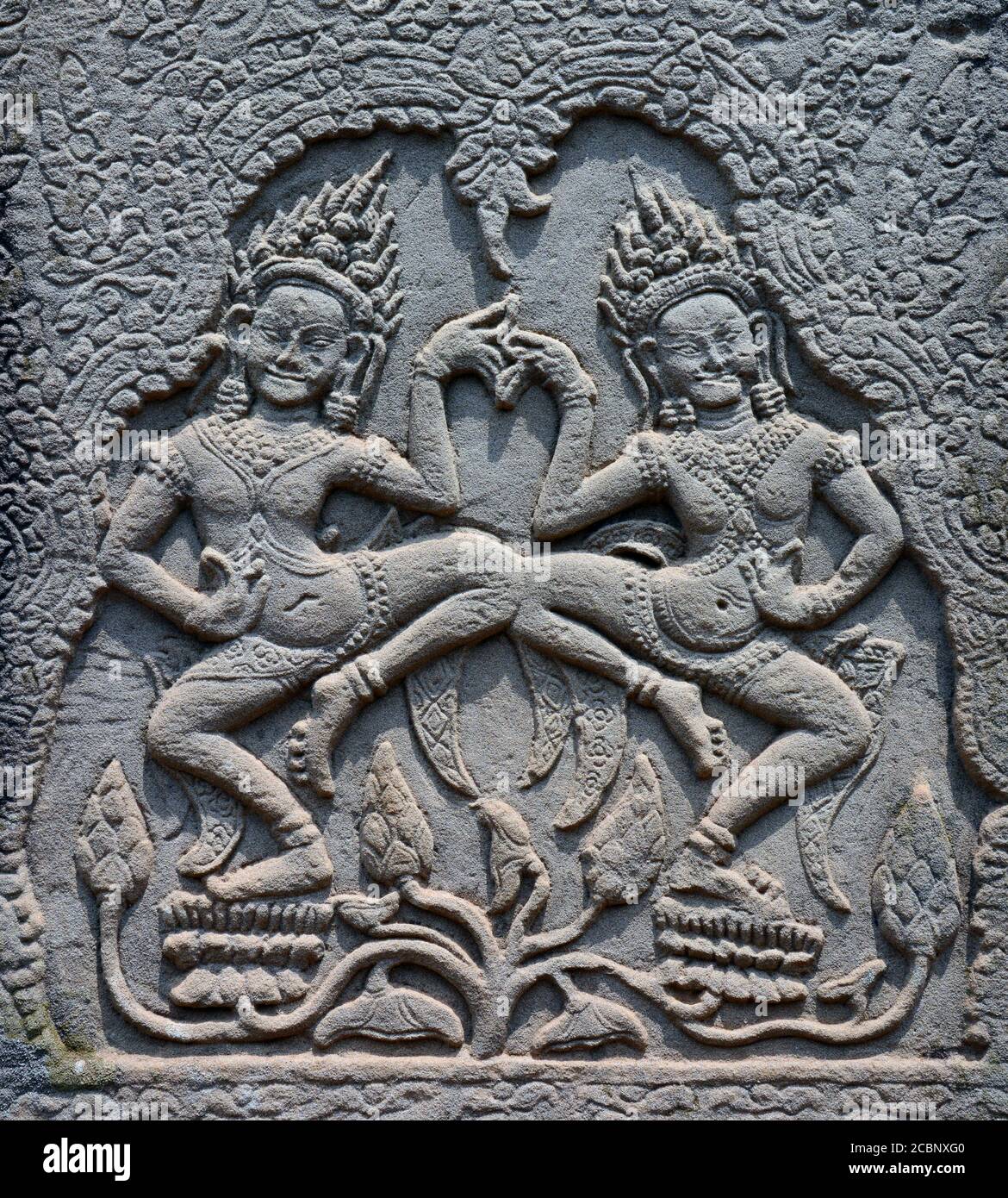 Stone carving of dancers, in a temple at Angkor Wat, Cambodia Stock
