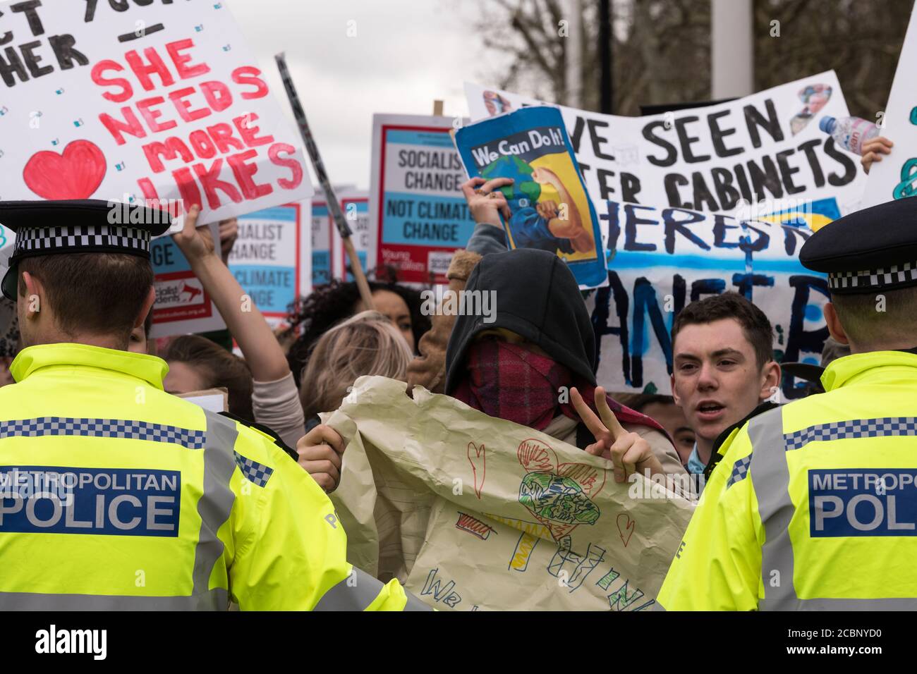 London, UK - Mar 15, 2019: Kids on strike from school. The Metropolitan Police holding them back from overrunning the Mall and Victoria statue. Stock Photo