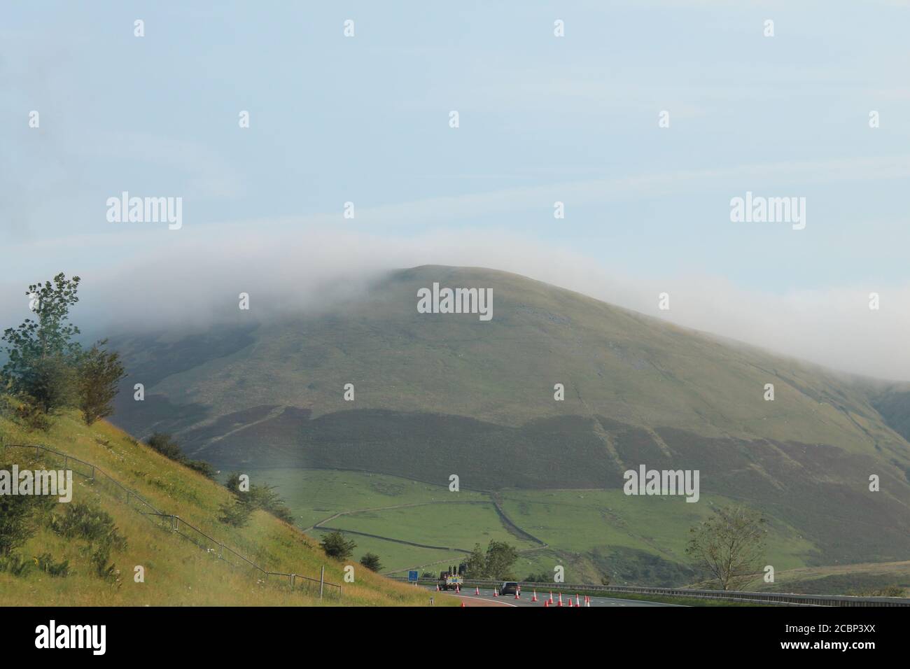 clouds covering the top of hills with copy space Stock Photo