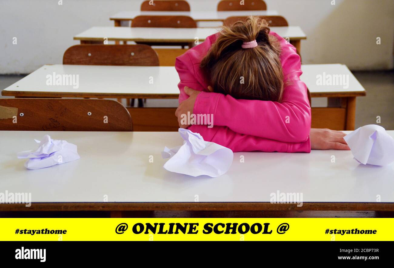 Schoolgirl: One sad and lonely student in the classroom at school Stock Photo