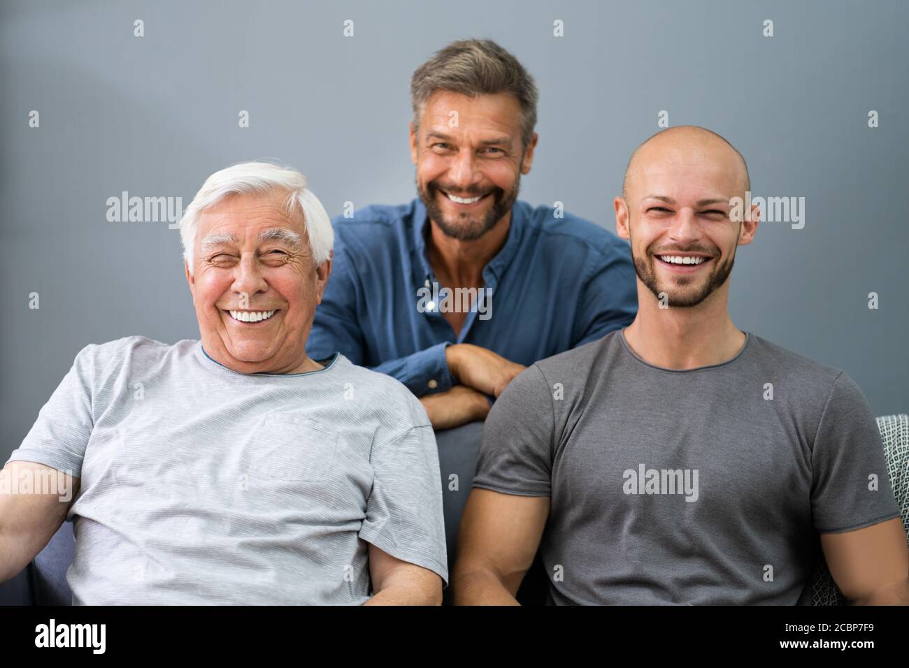 Three Generation Men Family Portraits In Living Room Stock Photo