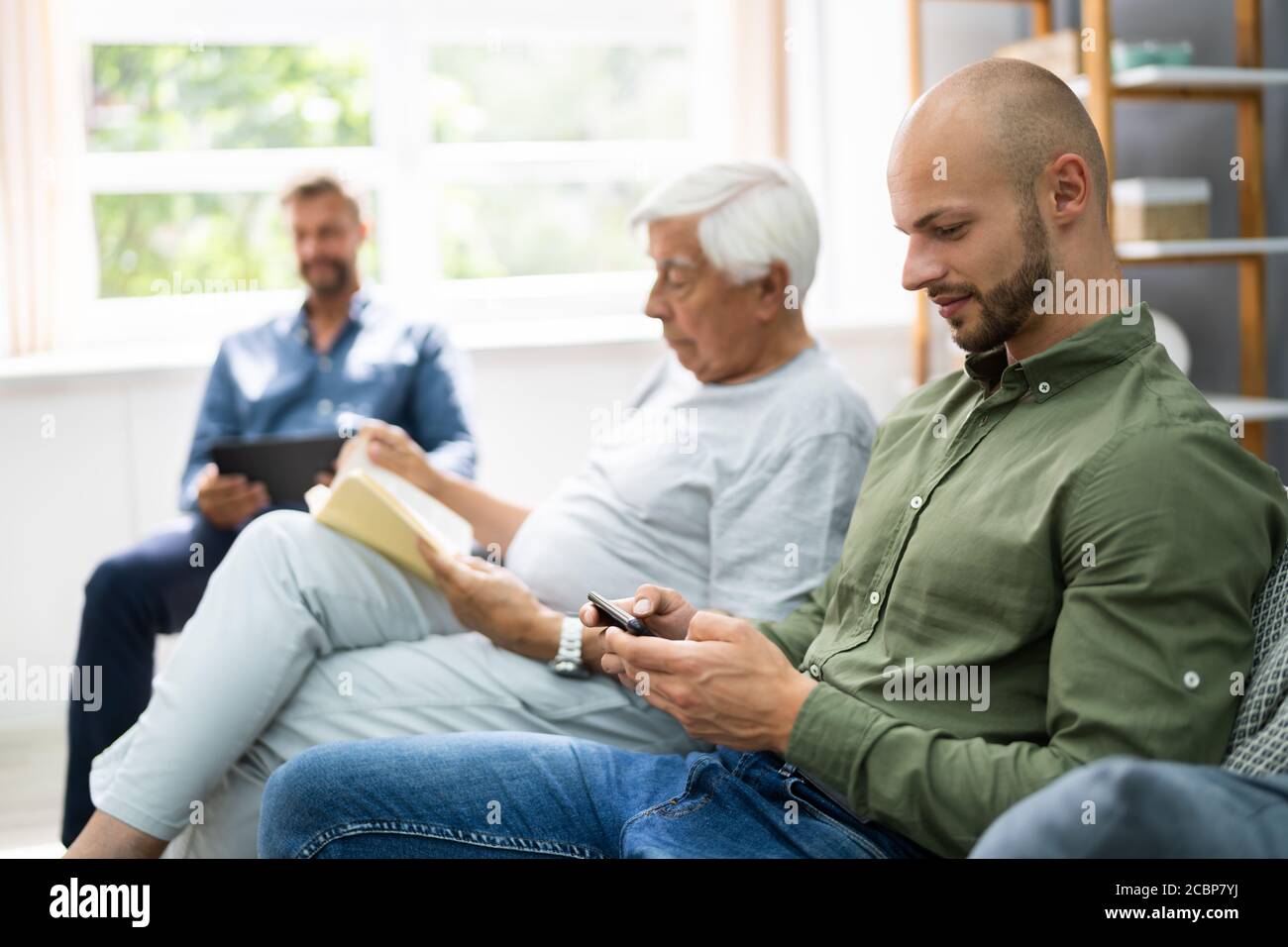 Three Generation Men Spending Time Together At Home Stock Photo