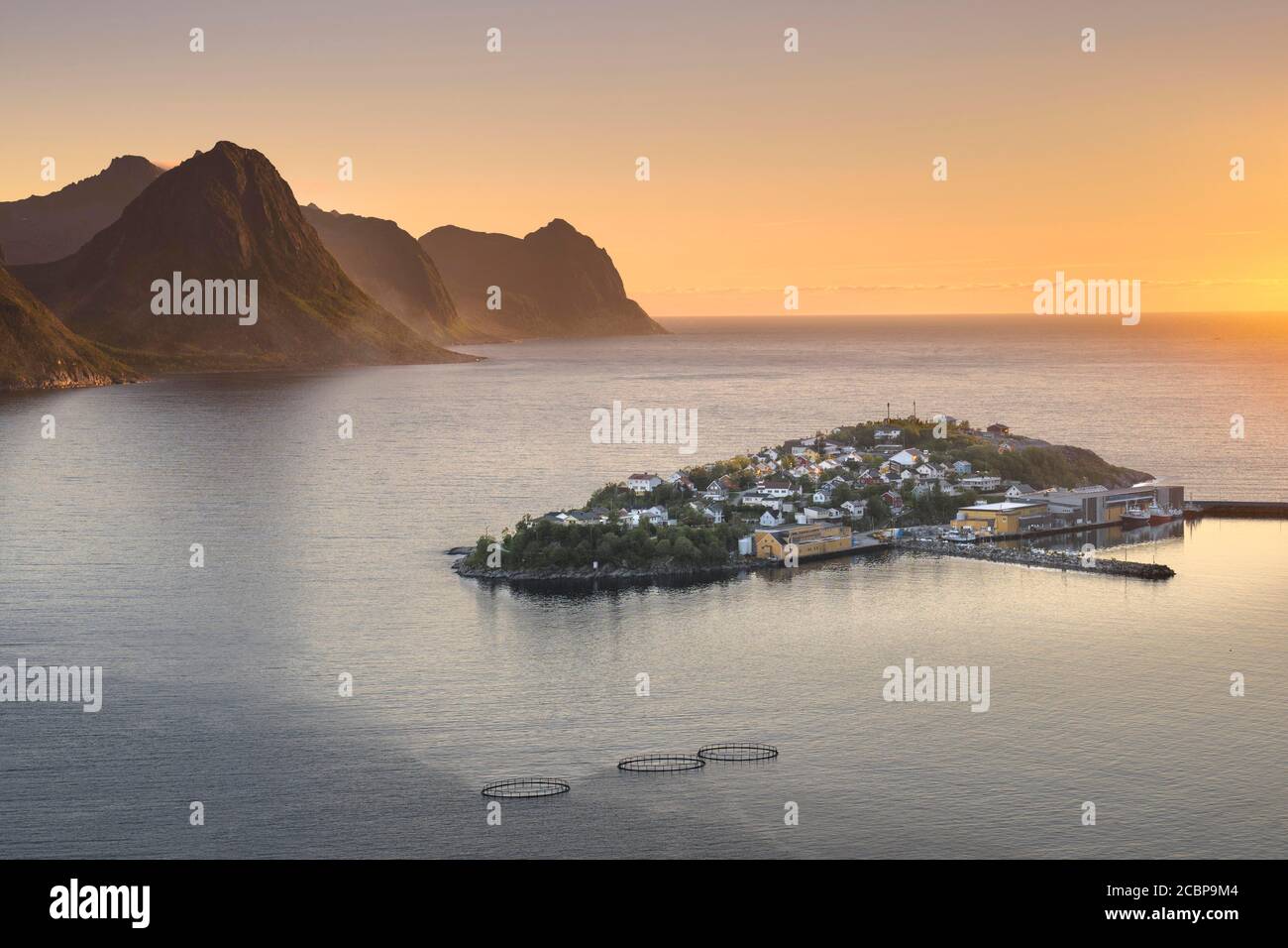 Island with place Husoy in the fjord at low sun with atmospheric light, island Senja, Husoy, Troms, Norway Stock Photo