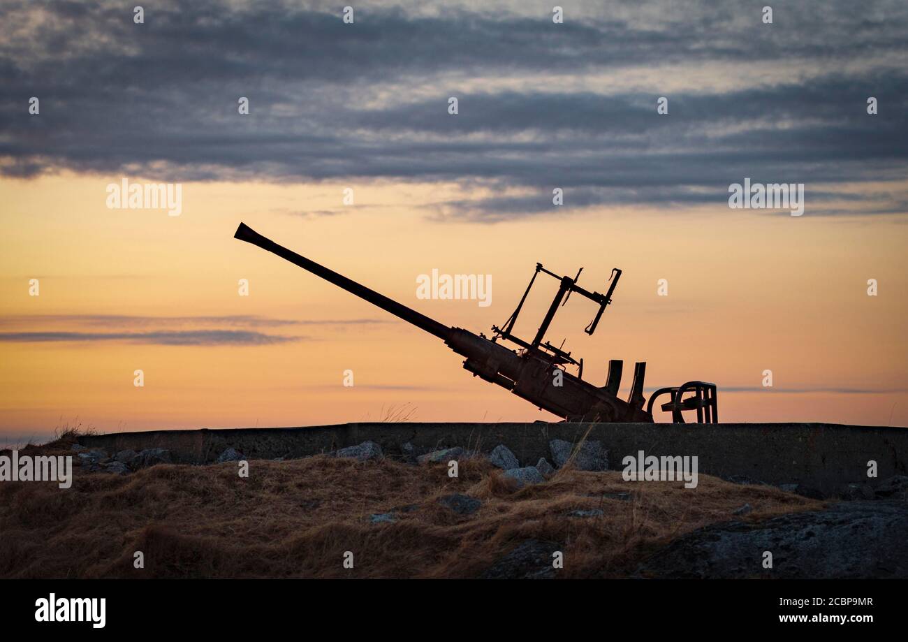Anti-aircraft gun position at the sea from the 2nd world war against the light of the evening sun, Senjehestneset, Senja Island, Troms, Norway Stock Photo