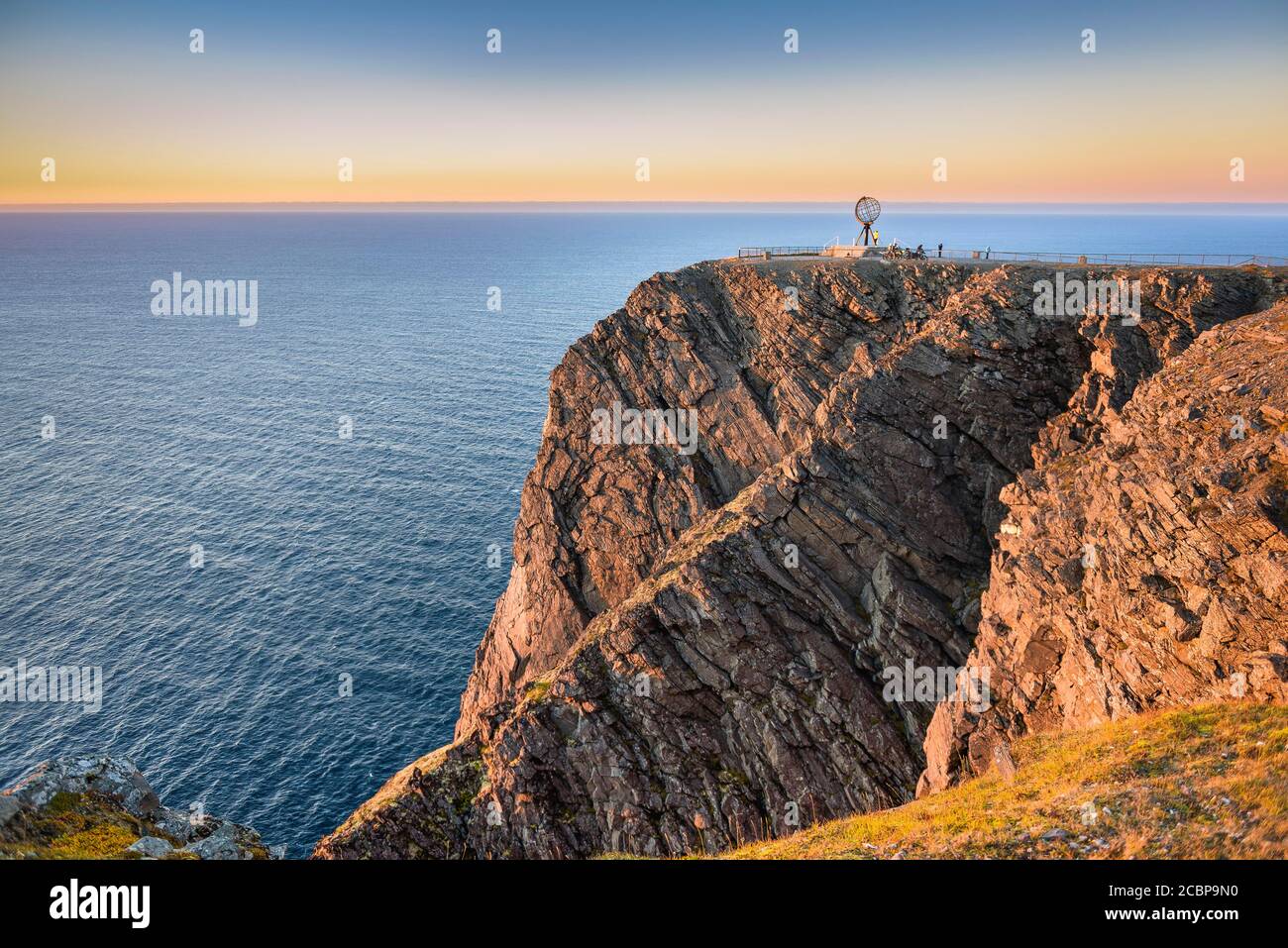 North Cape cliff with steel globe in the light of the midnight sun, Nordkapp, Finnmark, Norway Stock Photo