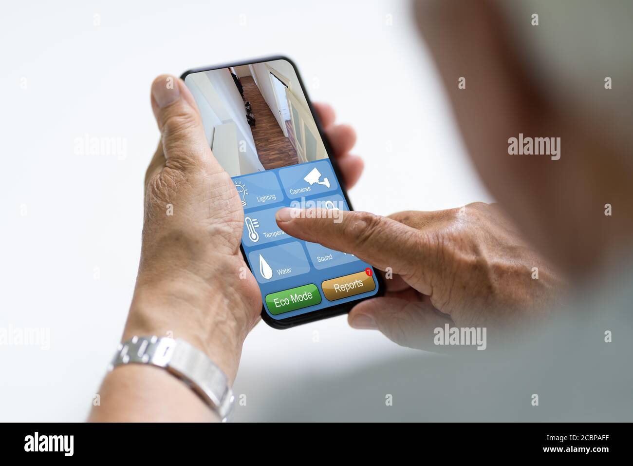 Elder Using Home Heating Control And Alarm Automation Stock Photo