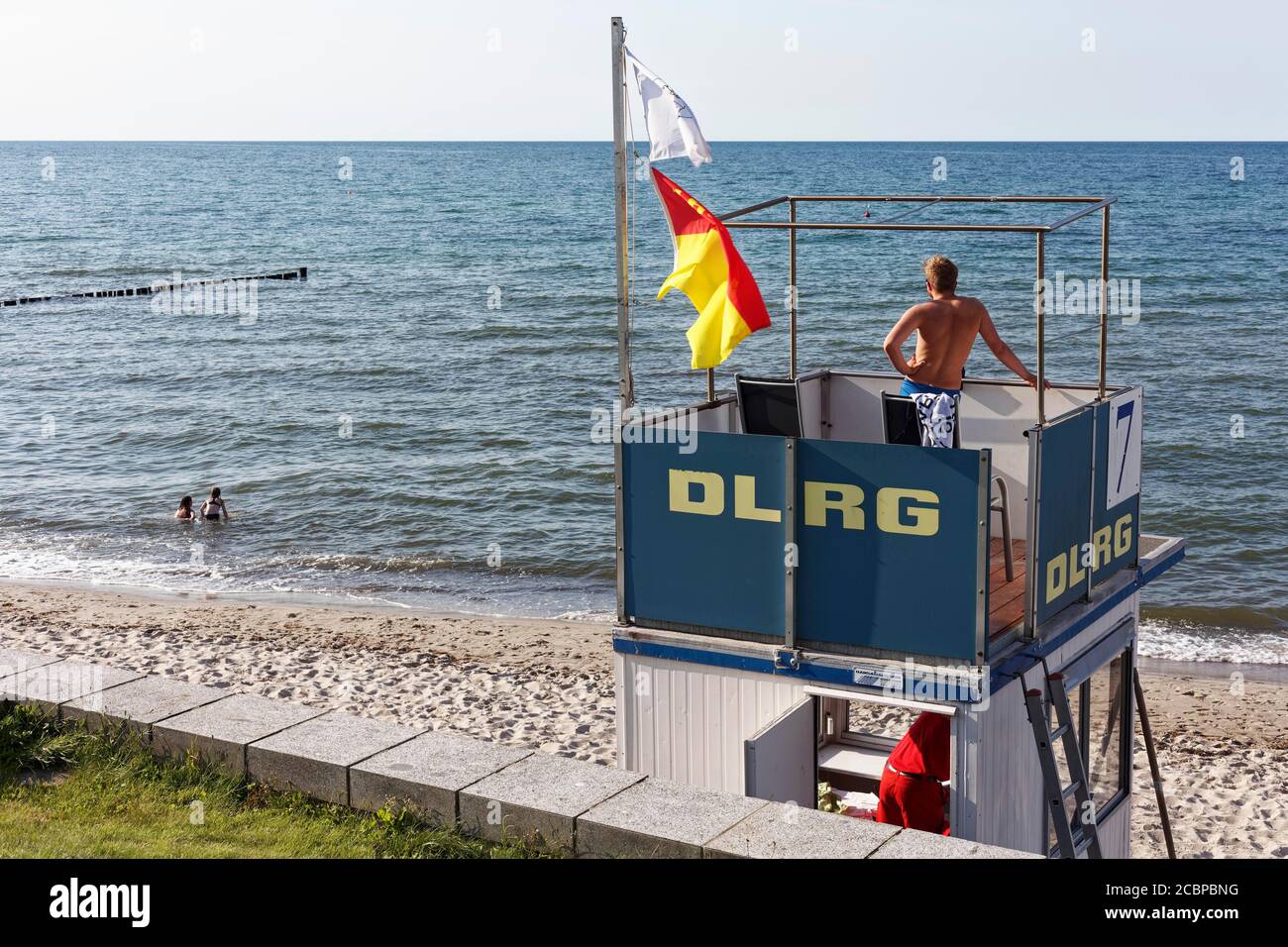Beach guard observes two bathers, DLRG tower at the Baltic Sea, Kuehlungsborn, Mecklenburg-Western Pomerania, Germany Stock Photo
