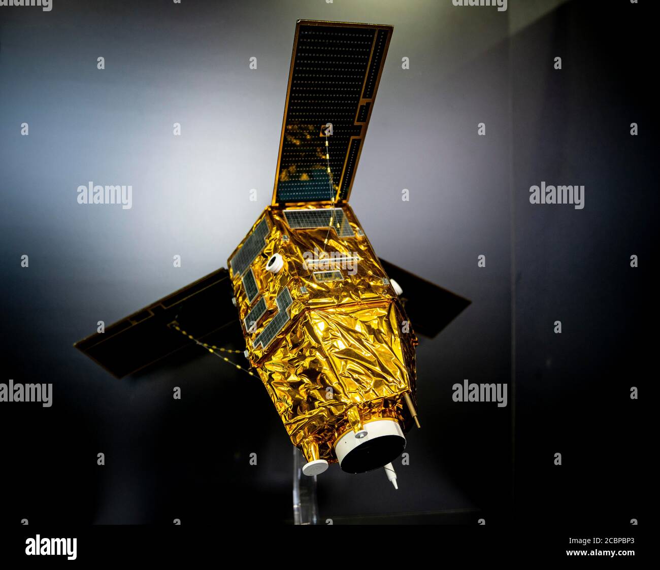 Model of a satellite with solar panel and golden heat protection foil Stock Photo