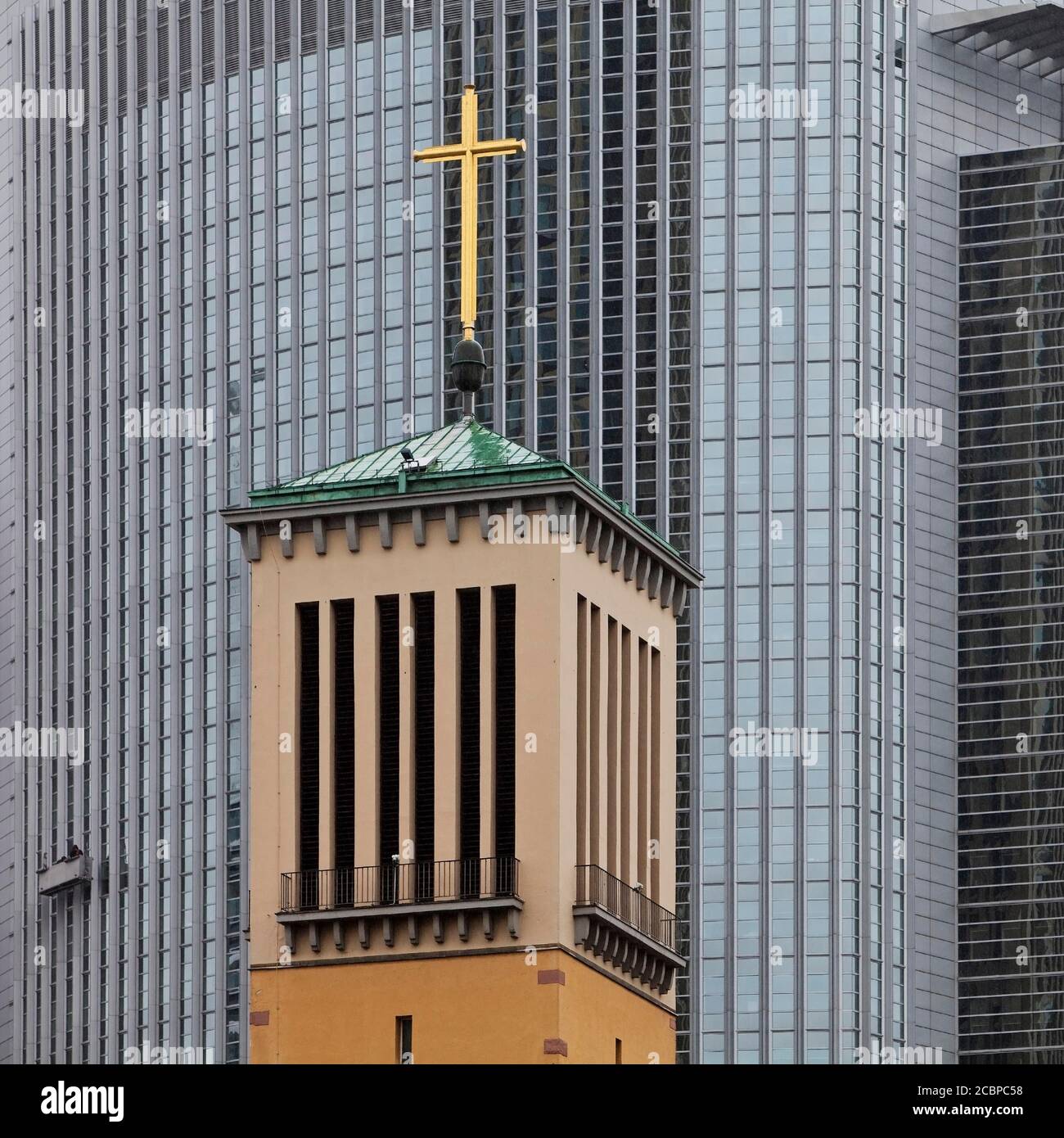 Old bell tower of the Matthaeuskirche in front of the modern aluminium facade of the Pollux office tower, Frankfurt am Main, Hesse, Germany Stock Photo